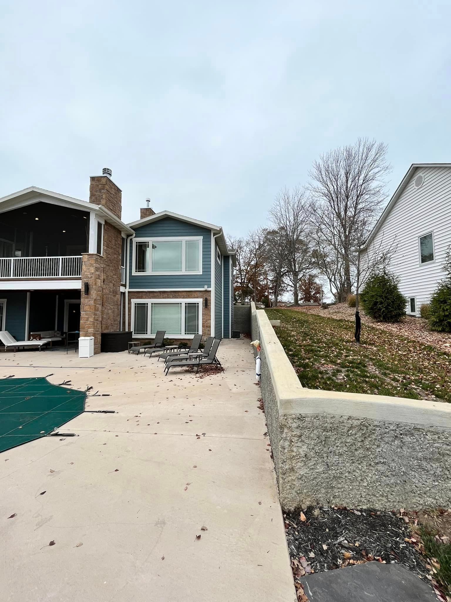 A large house with a swimming pool in front of it.