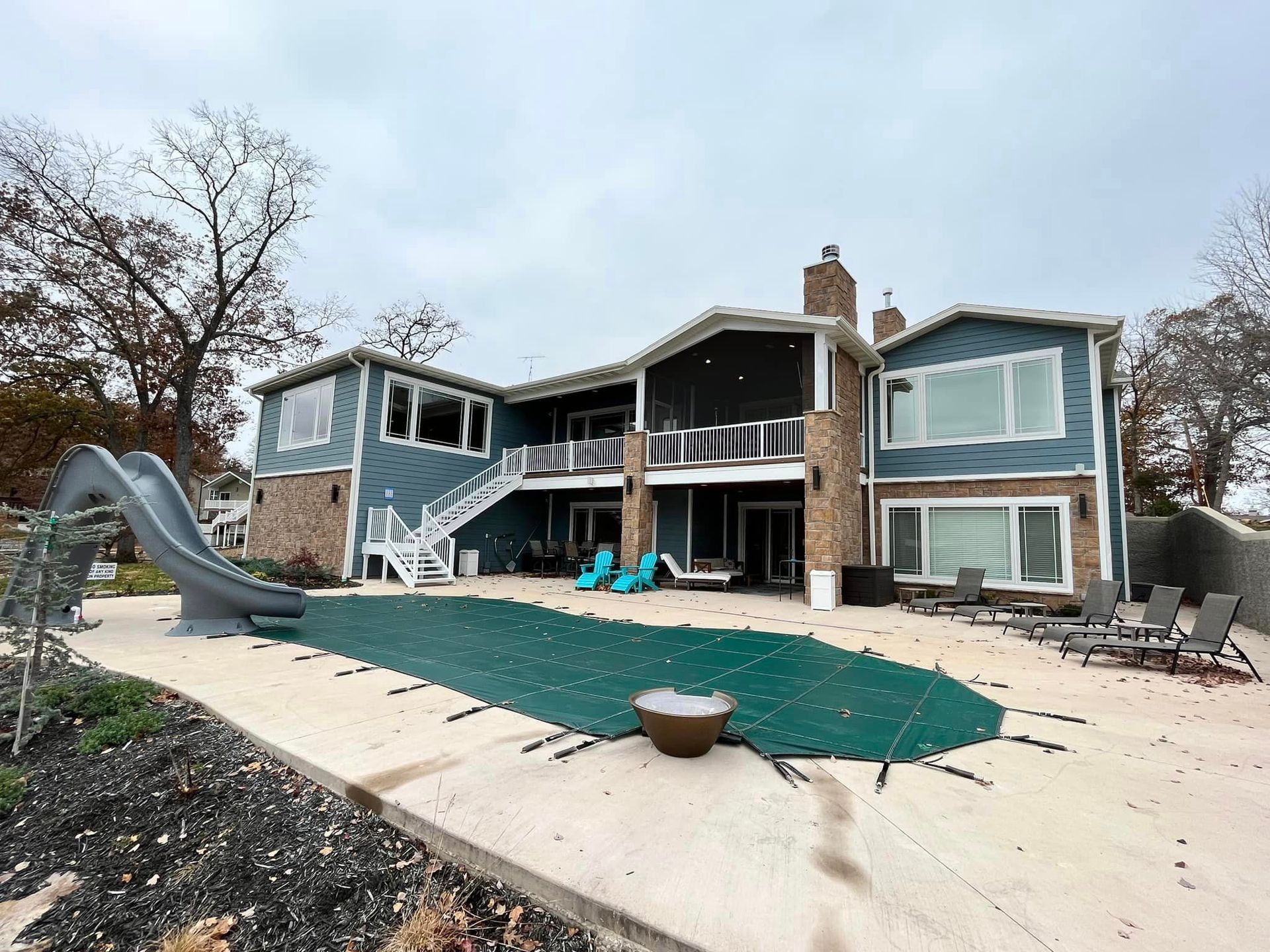 A large house with a swimming pool and a slide.