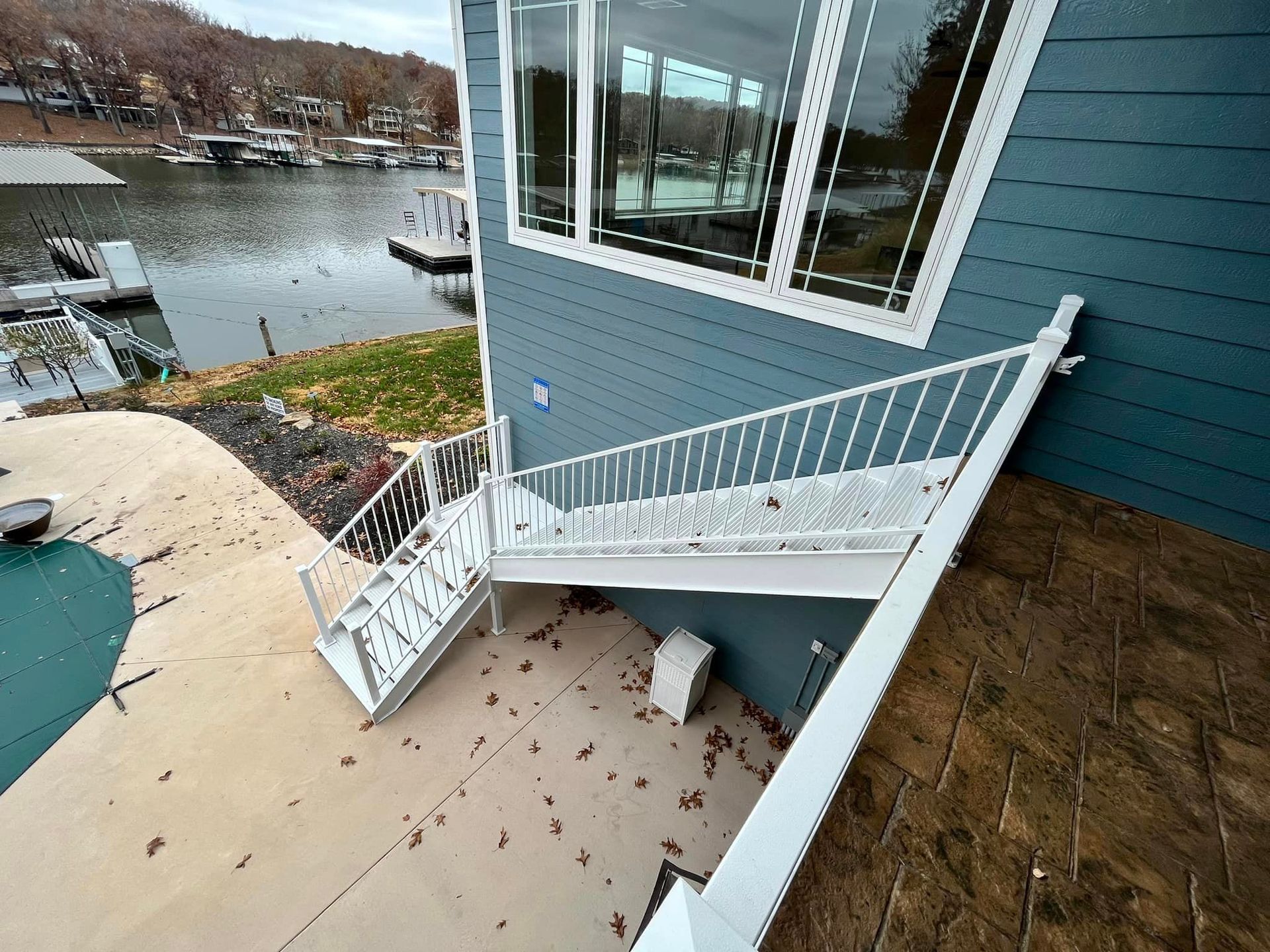 A blue house with white stairs leading up to it