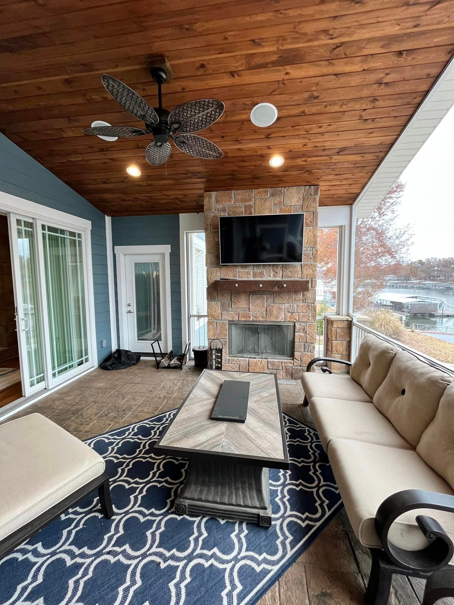 A living room with a fireplace , couch , coffee table and television.