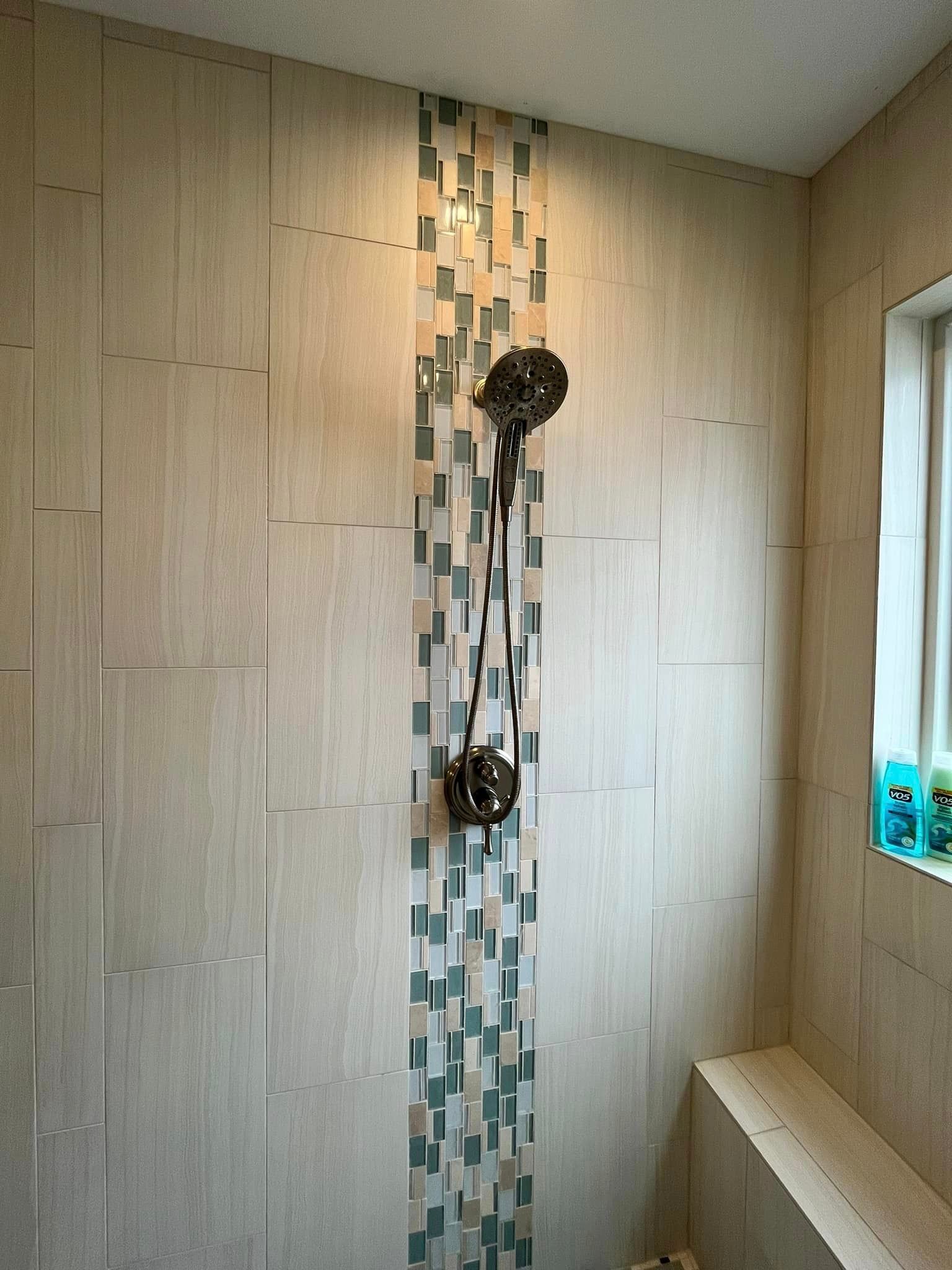 A bathroom with two shower heads and a window.