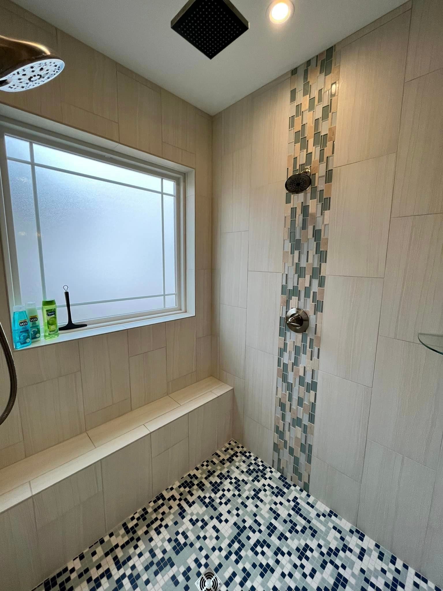 A bathroom with a shower and a window.
