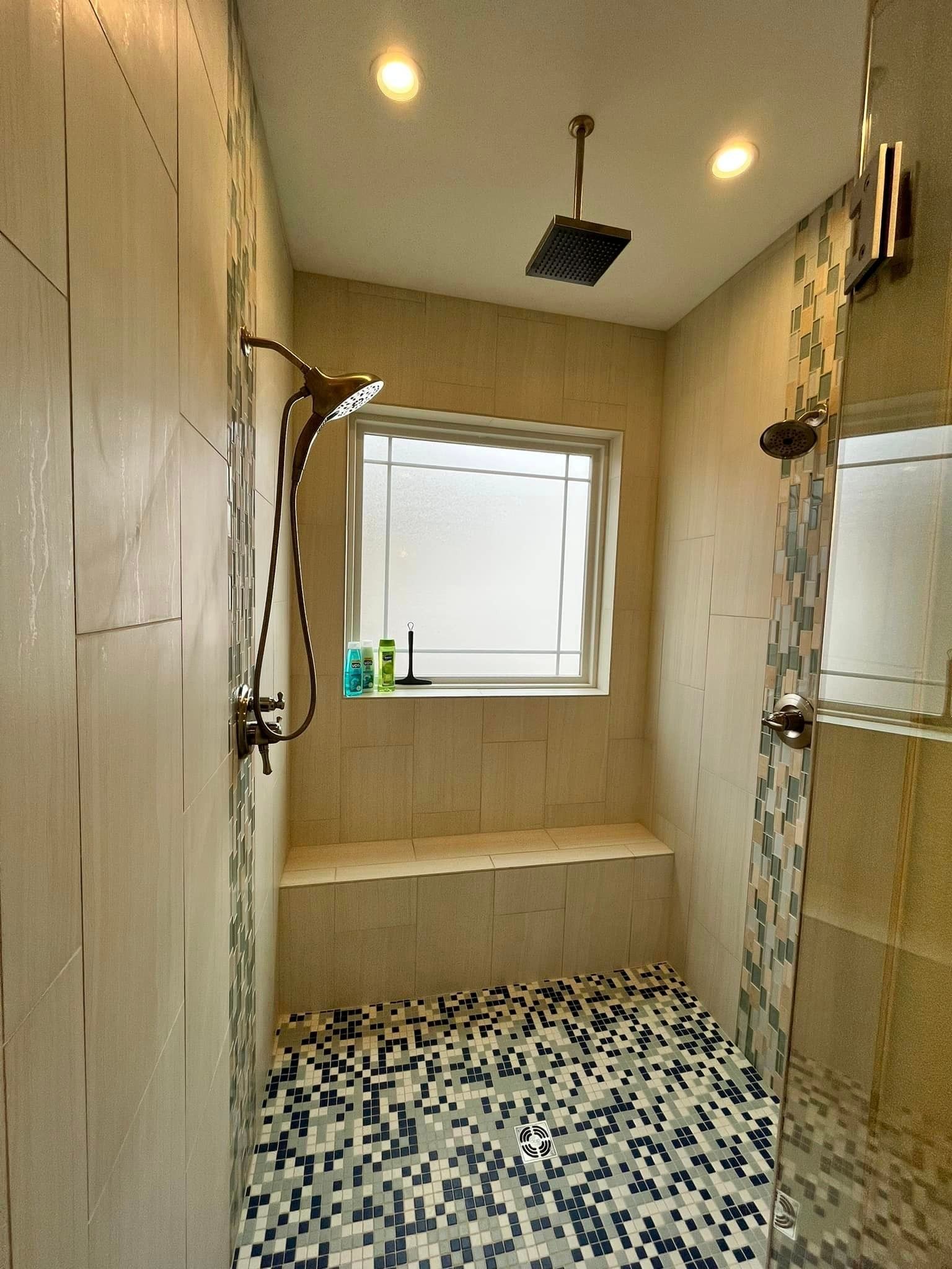 A bathroom with a shower and a window