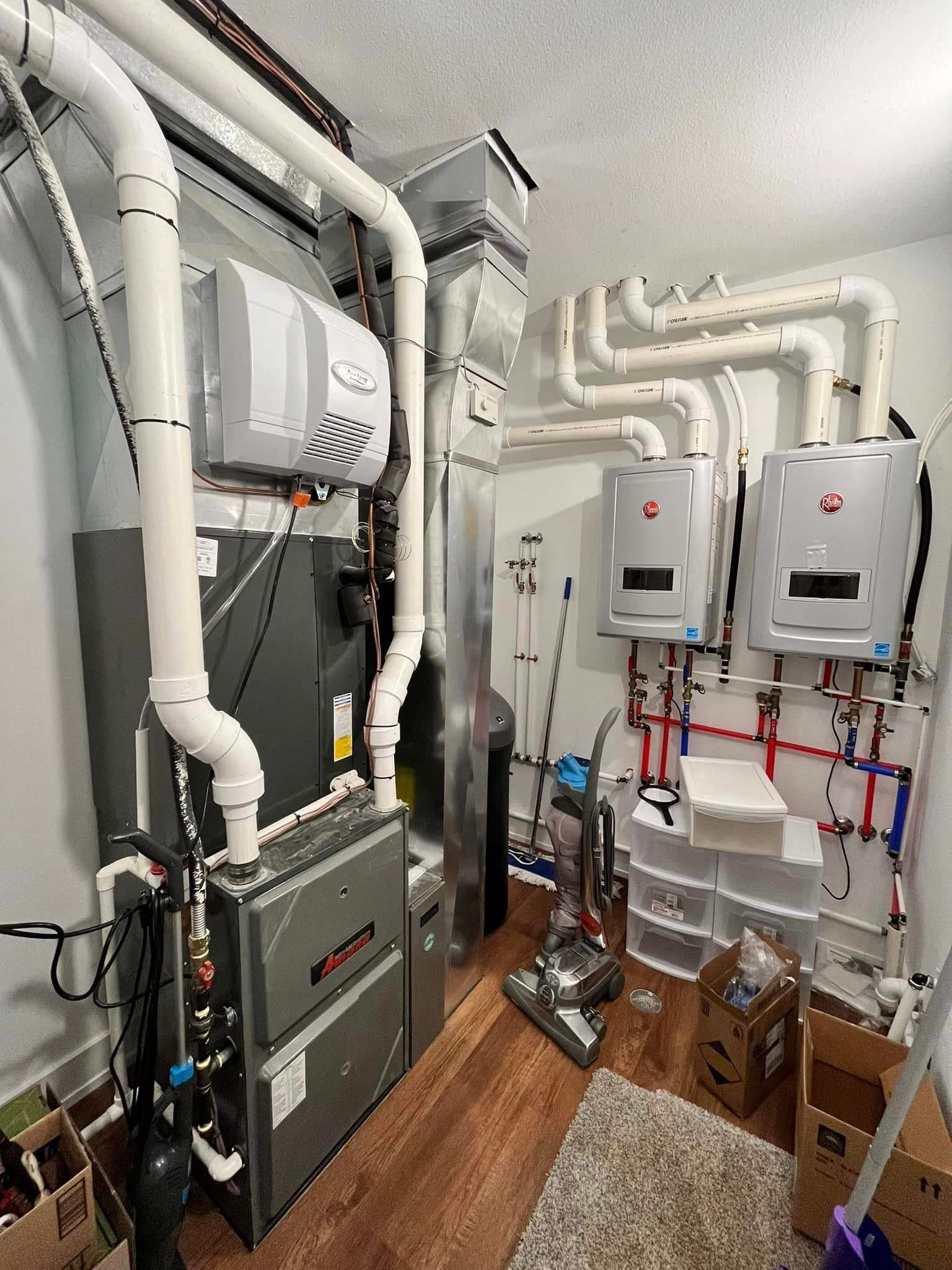 A room with a lot of pipes and boxes on the floor.