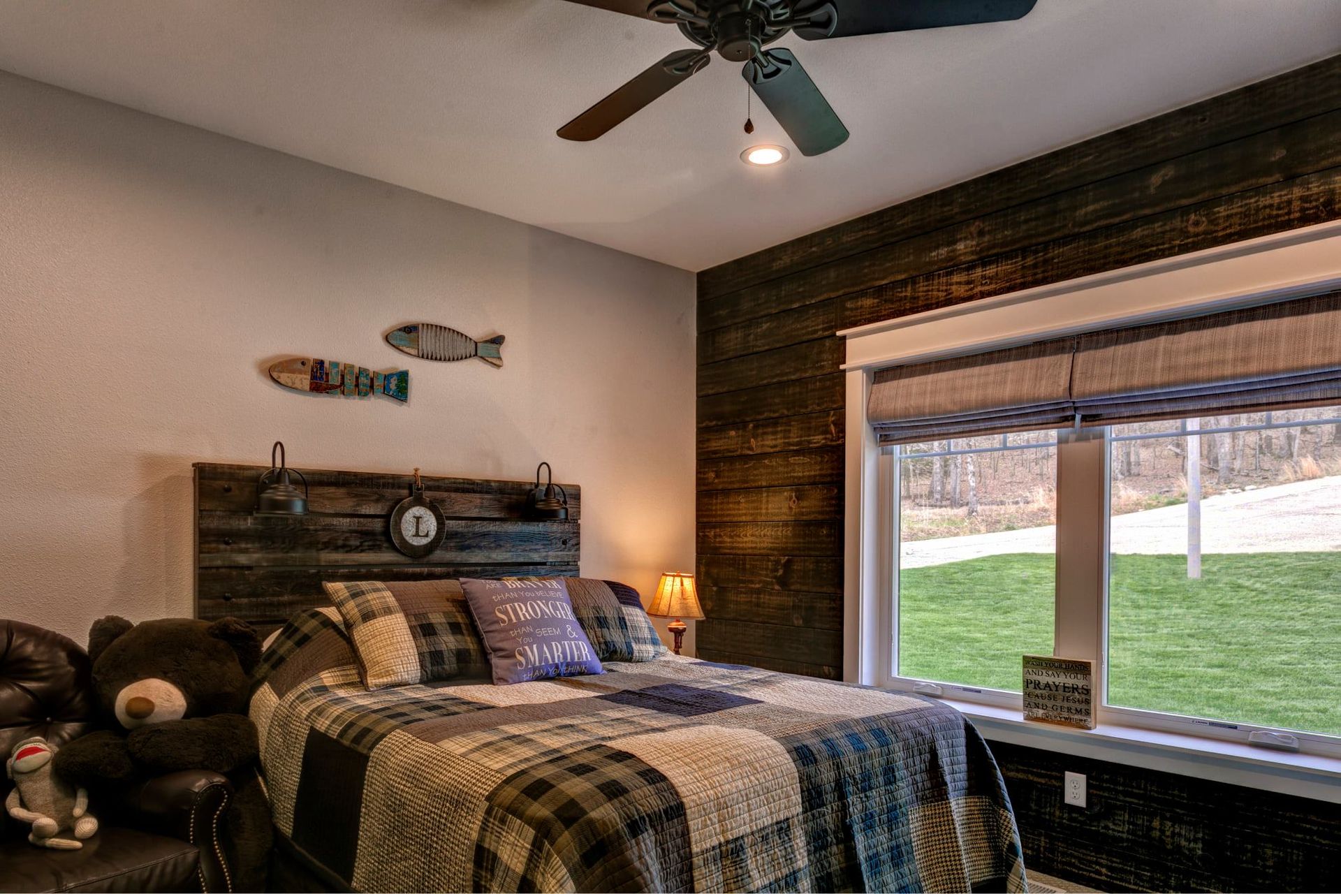A bedroom with a large bed and a ceiling fan