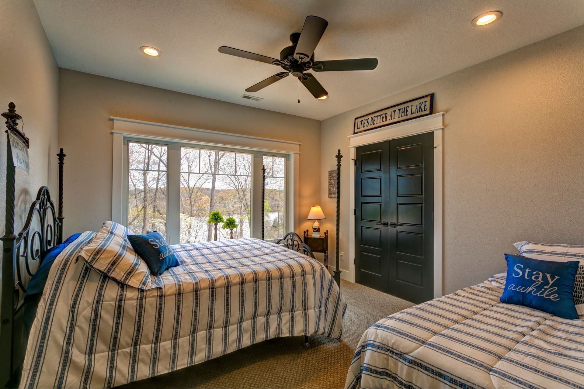 A bedroom with two beds and a ceiling fan.