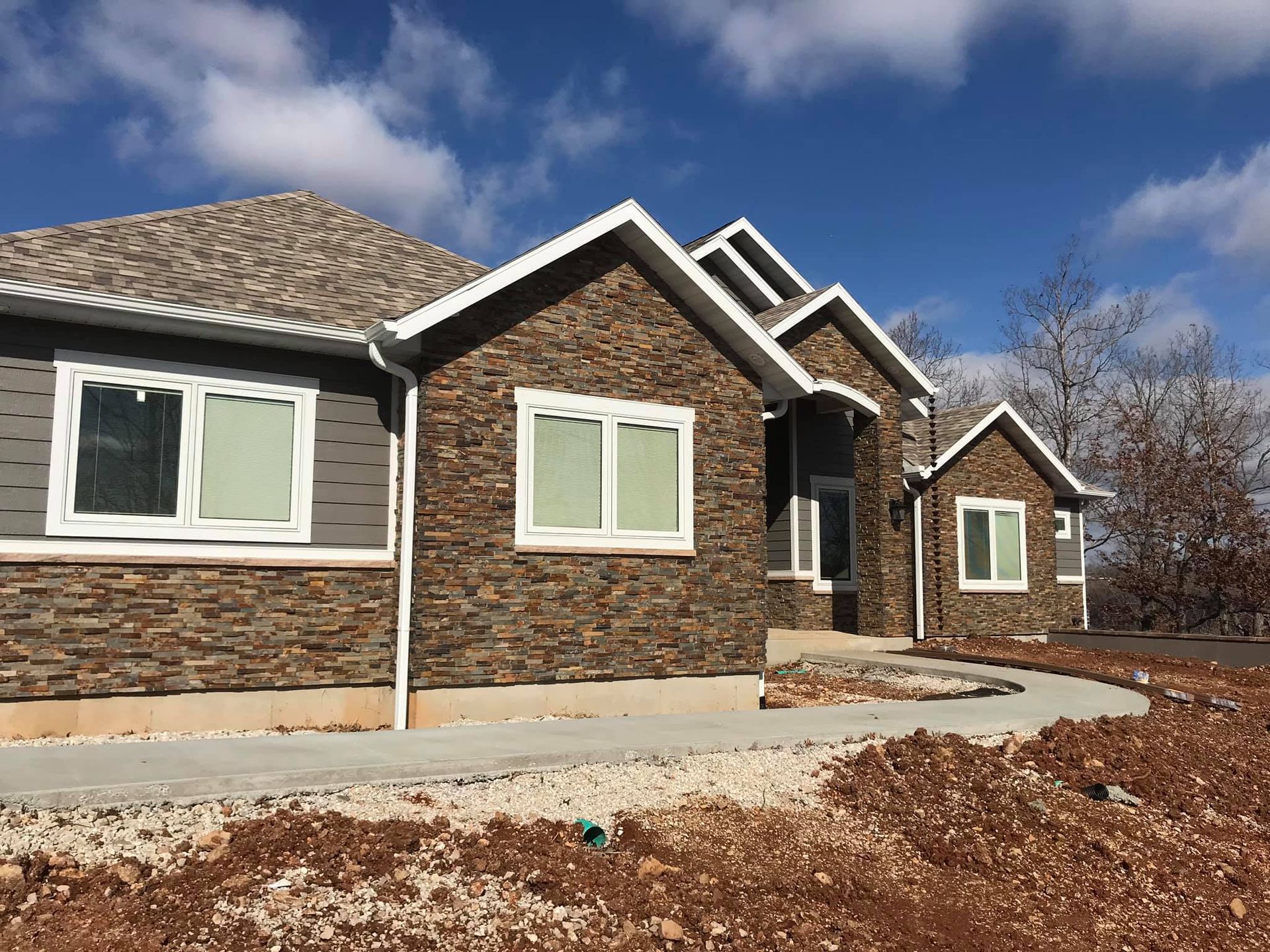 A large house with a lot of windows and a stone facade