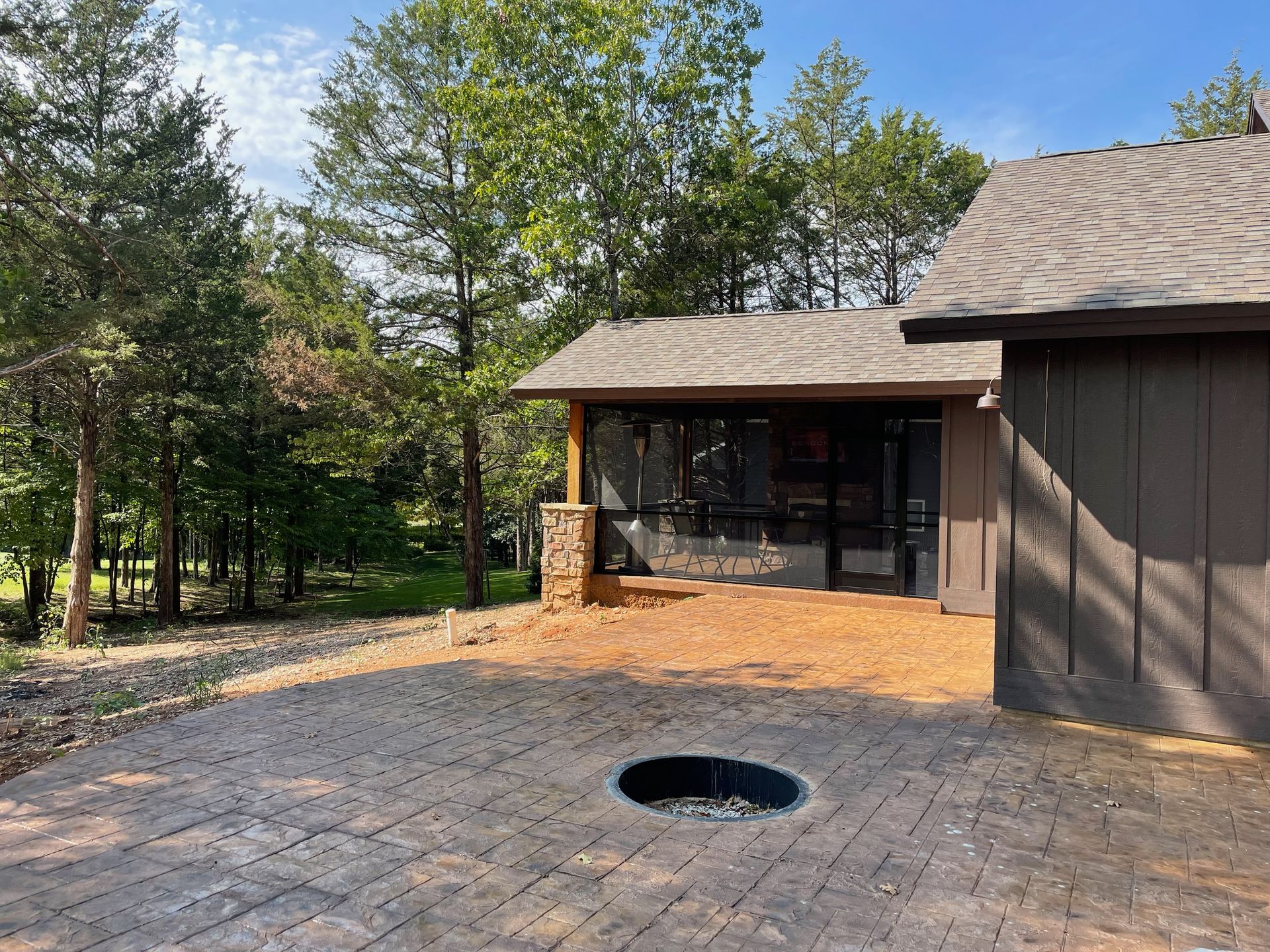 There is a fire pit in the backyard of a house.