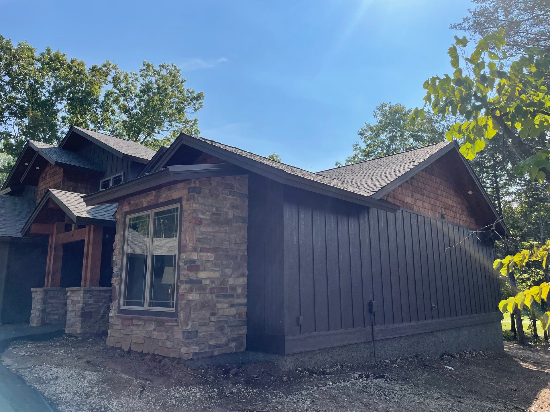 A house with a lot of windows and trees in the background