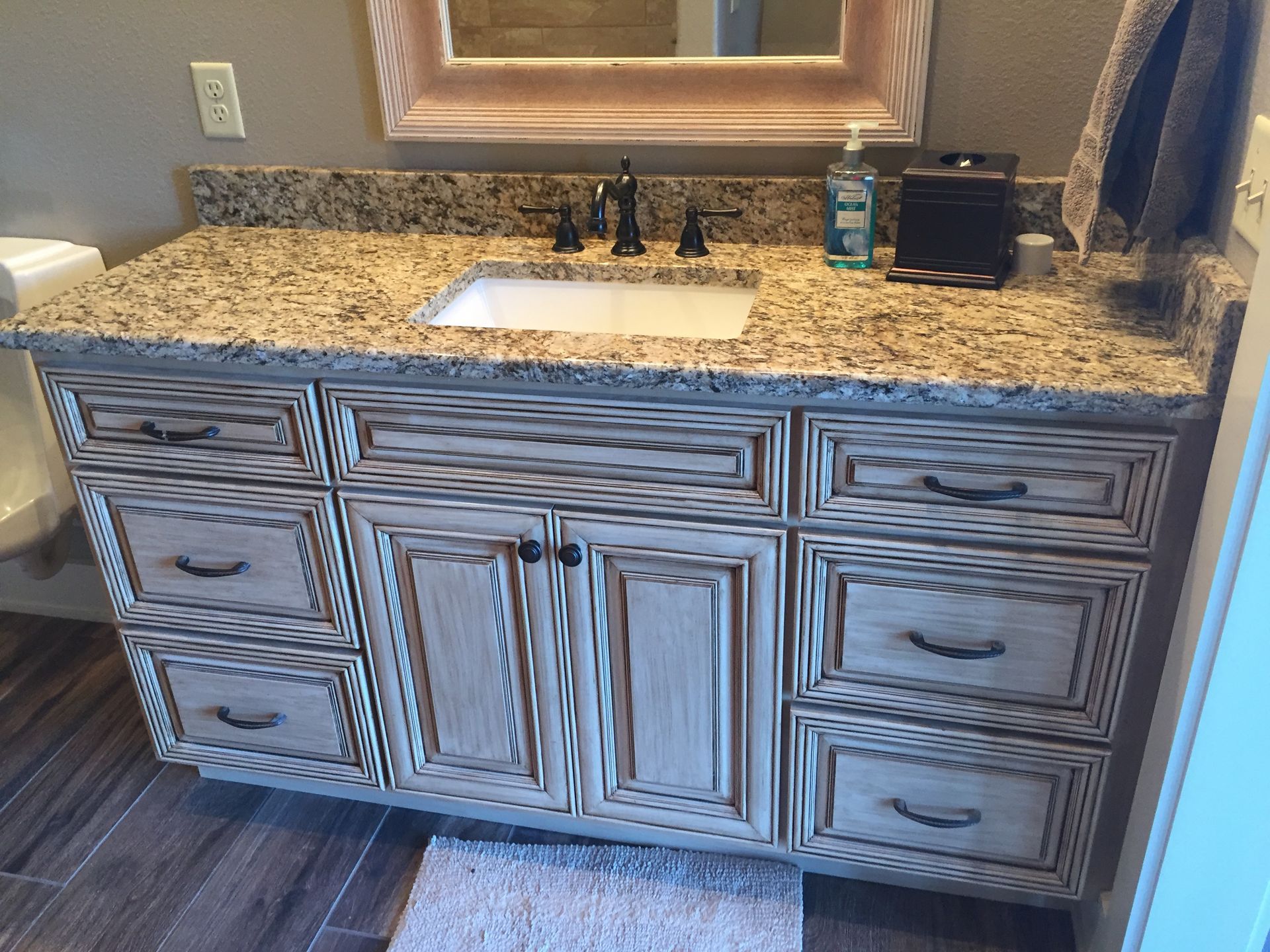 A bathroom vanity with a sink and a mirror