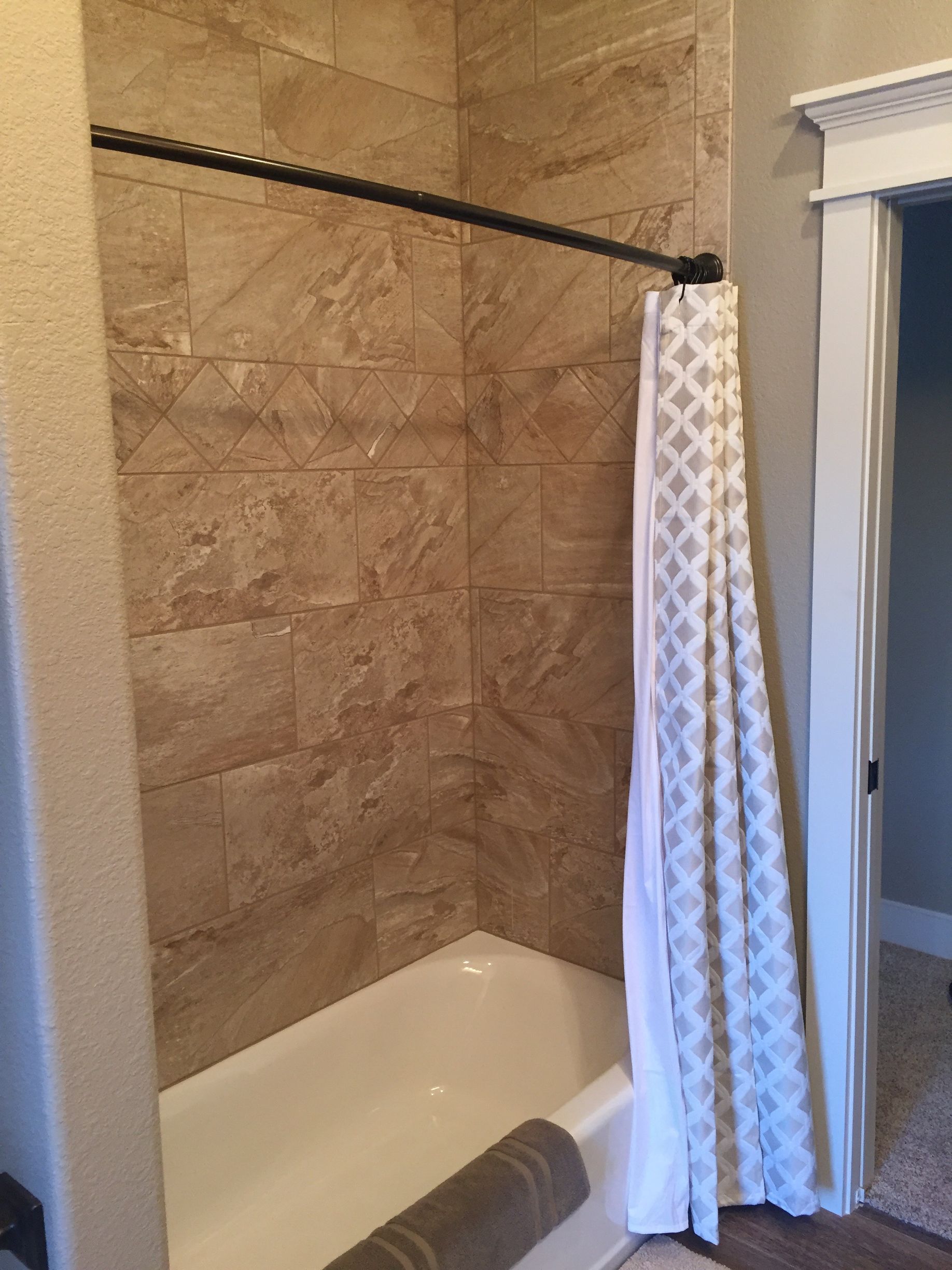 A bathroom with a bathtub and a shower curtain.