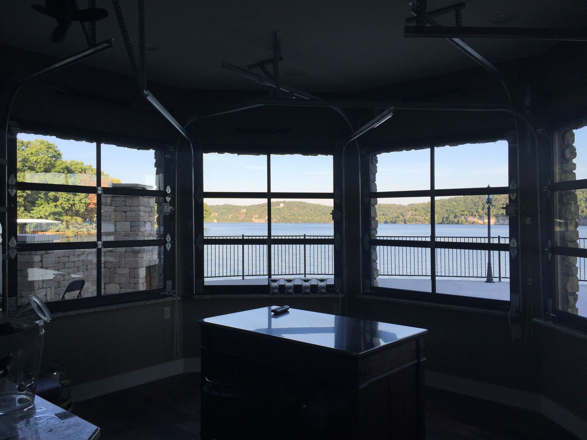 A room with a table and a view of a lake