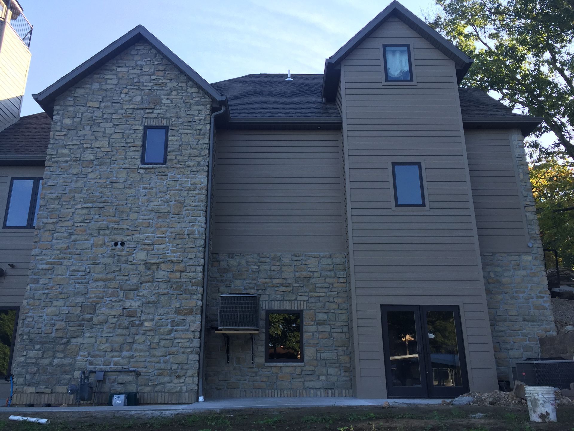 A large house with a lot of windows and a stone facade