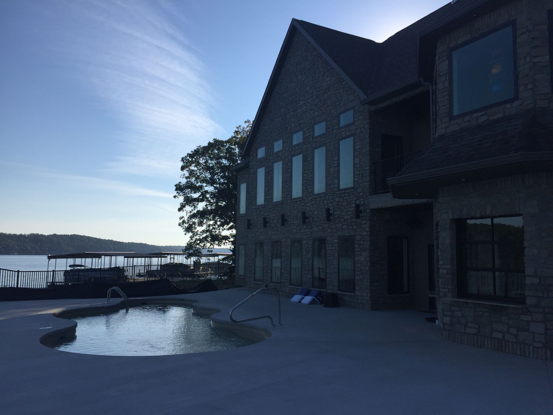 A large brick building with a pool in front of it