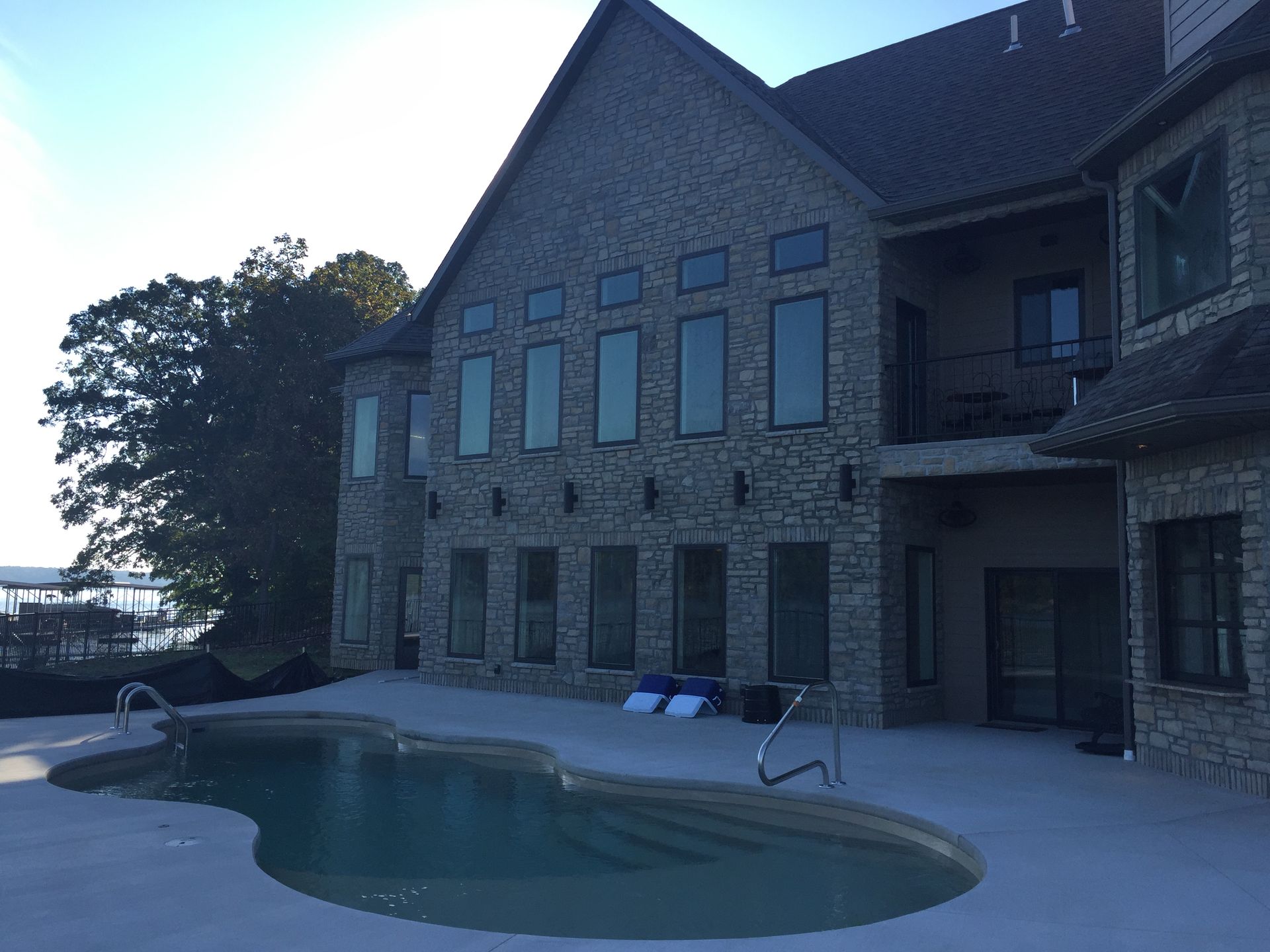 A large house with a swimming pool in front of it