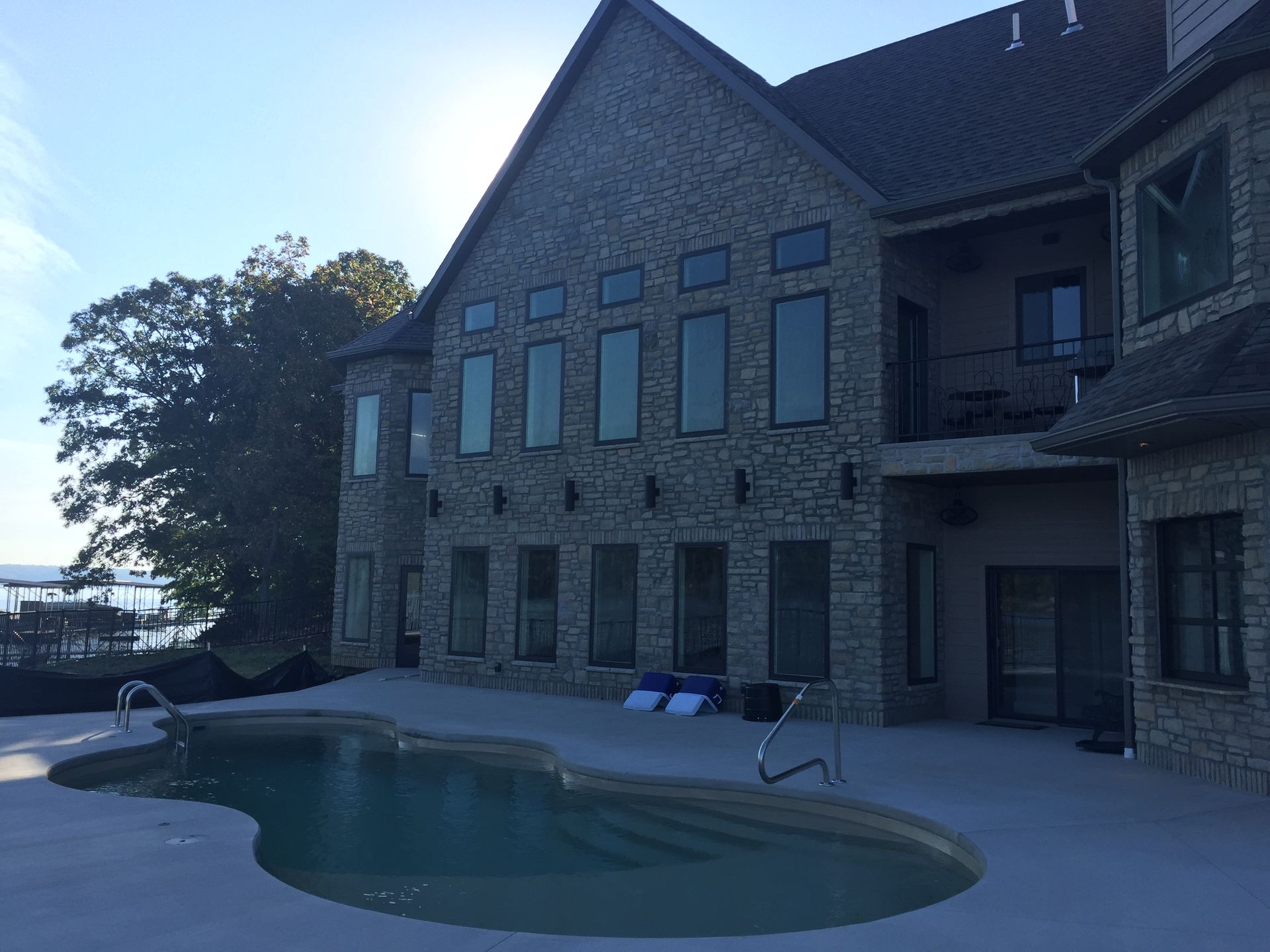 A large house with a swimming pool in front of it