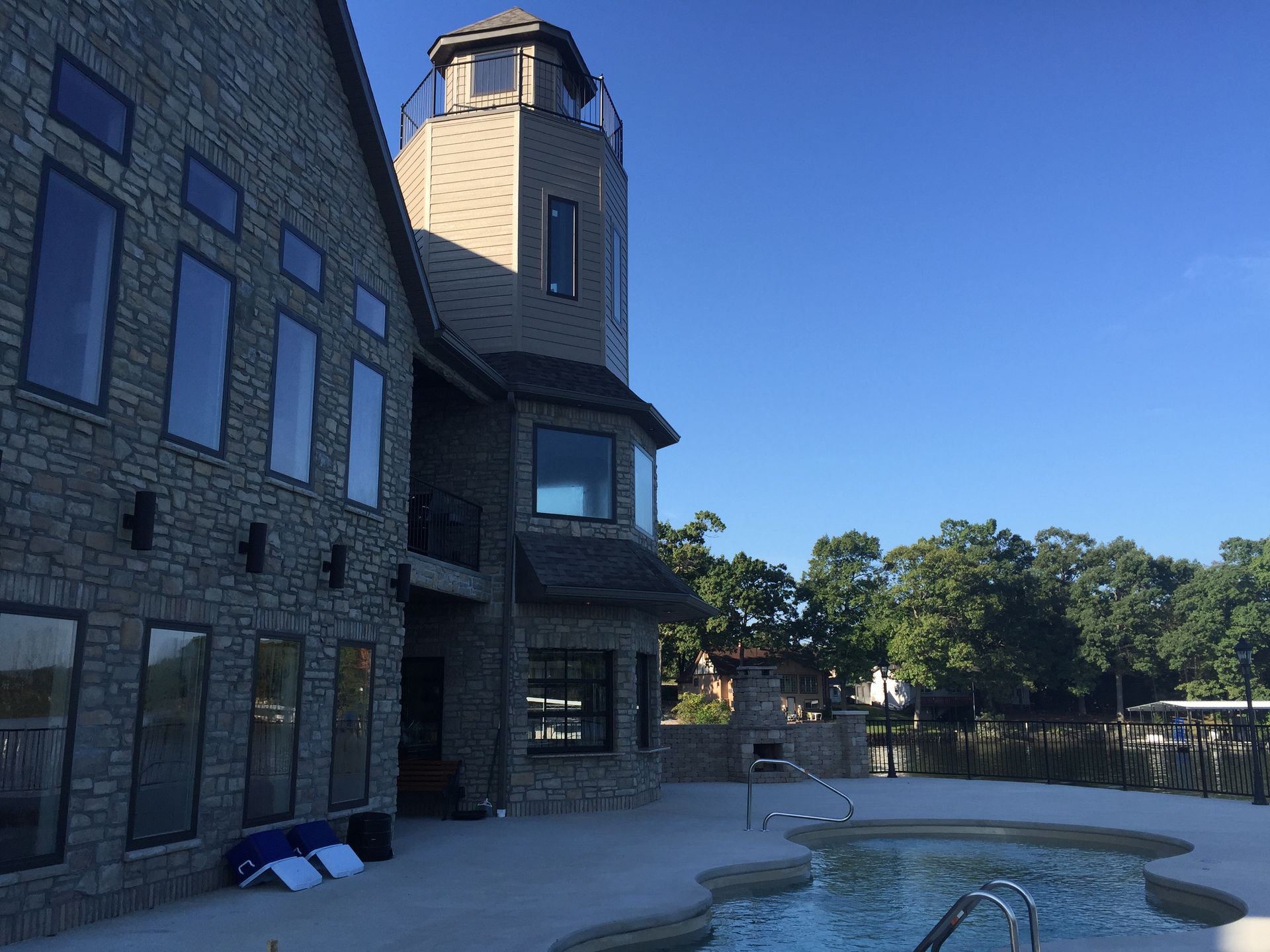 A large brick building with a pool in front of it