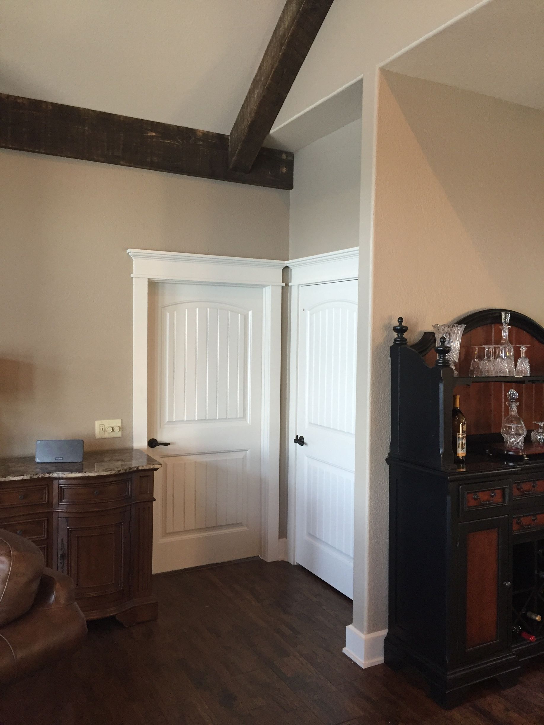 A living room with a dresser and a door