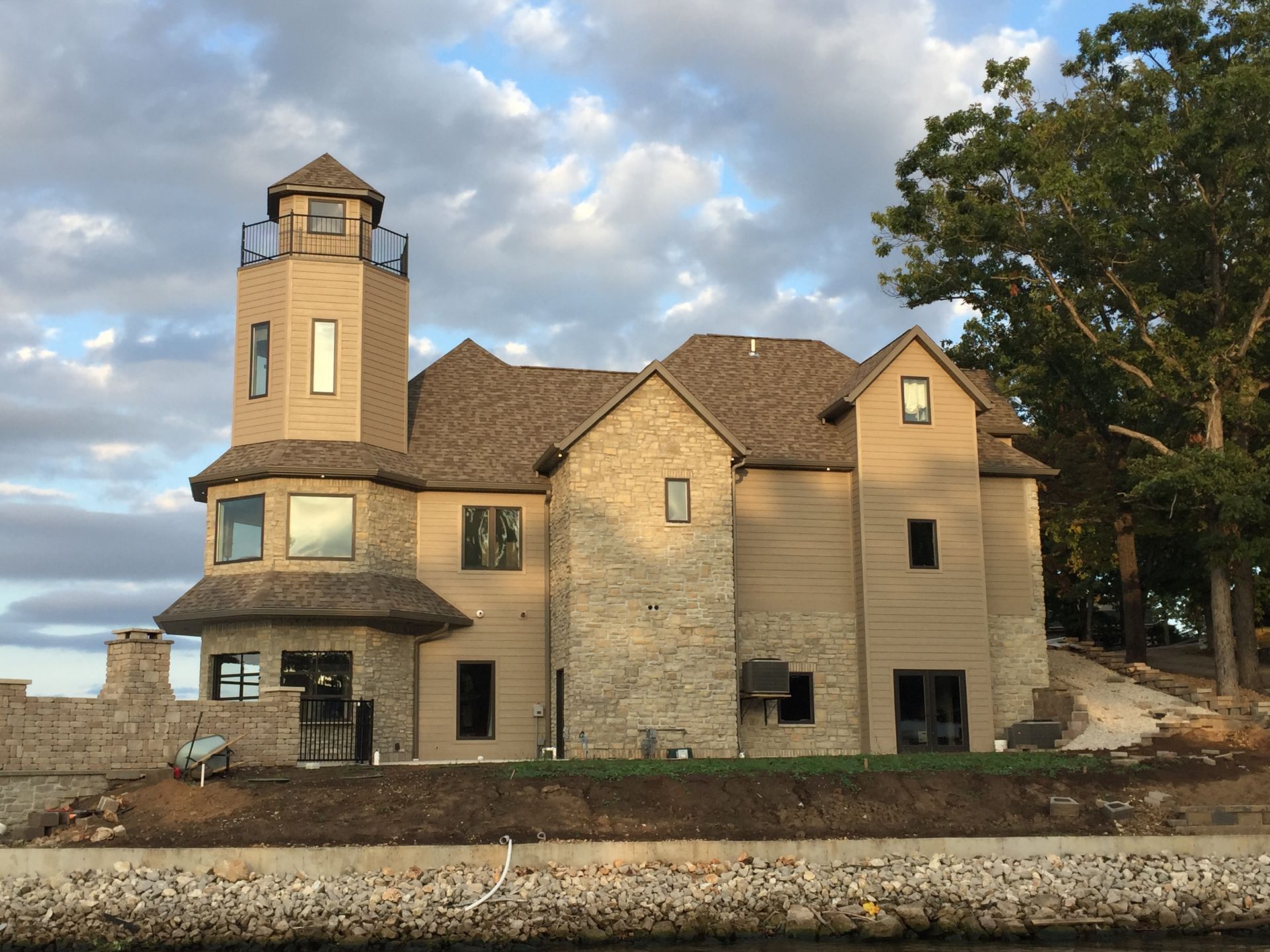 A large house with a lighthouse on top of it