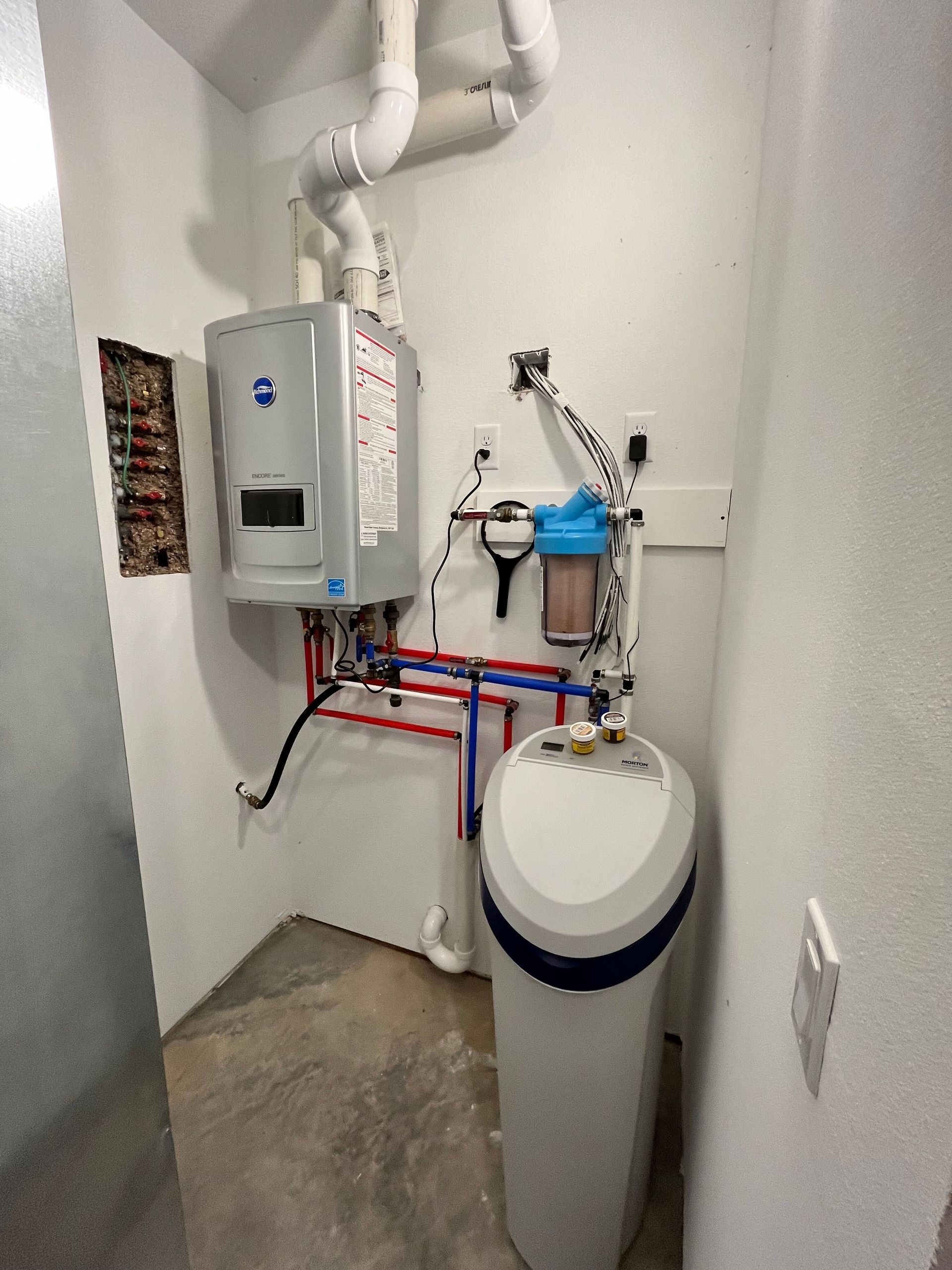 A room with a water heater and a water softener