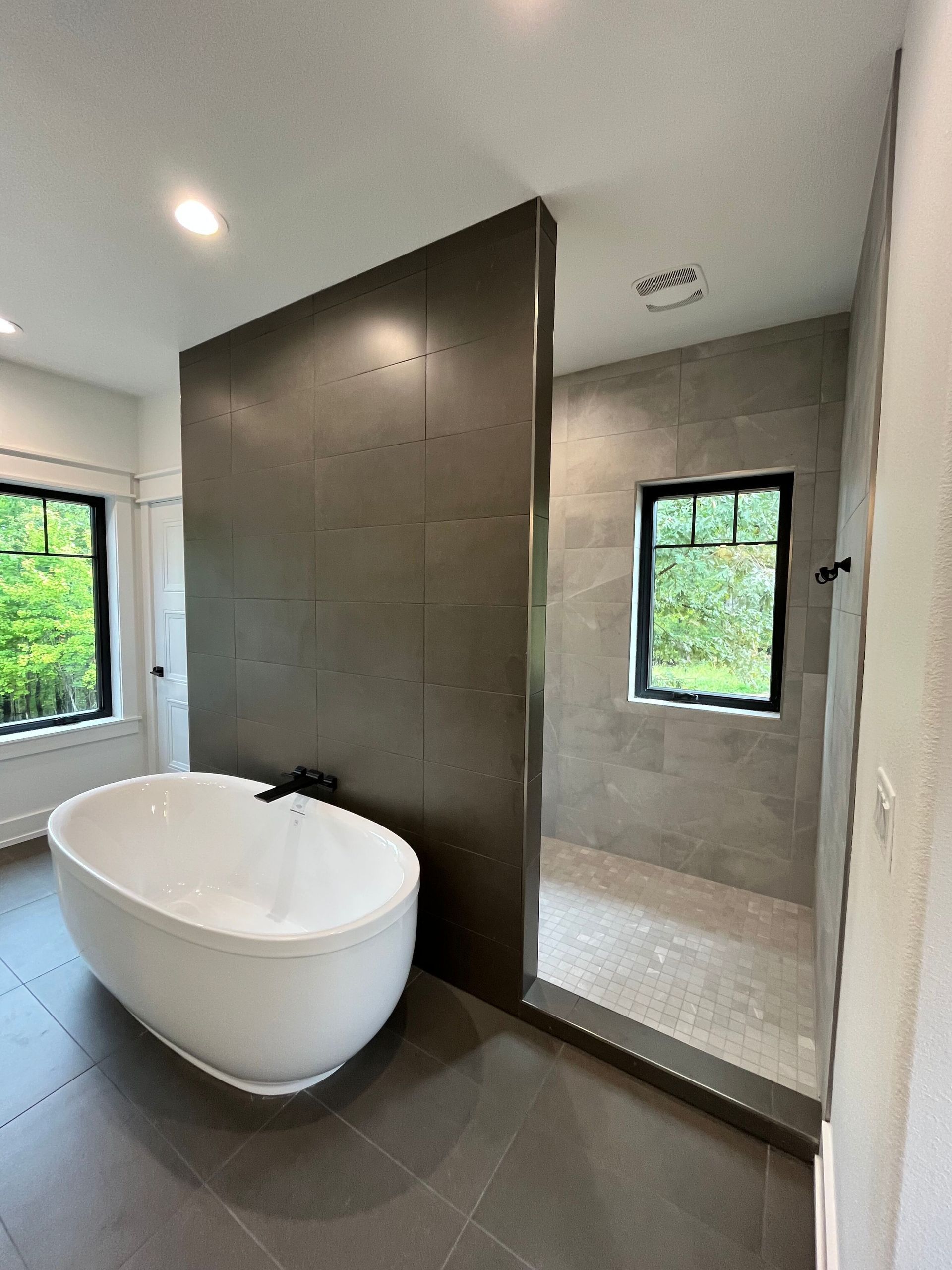 A bathroom with a bathtub and a walk in shower.