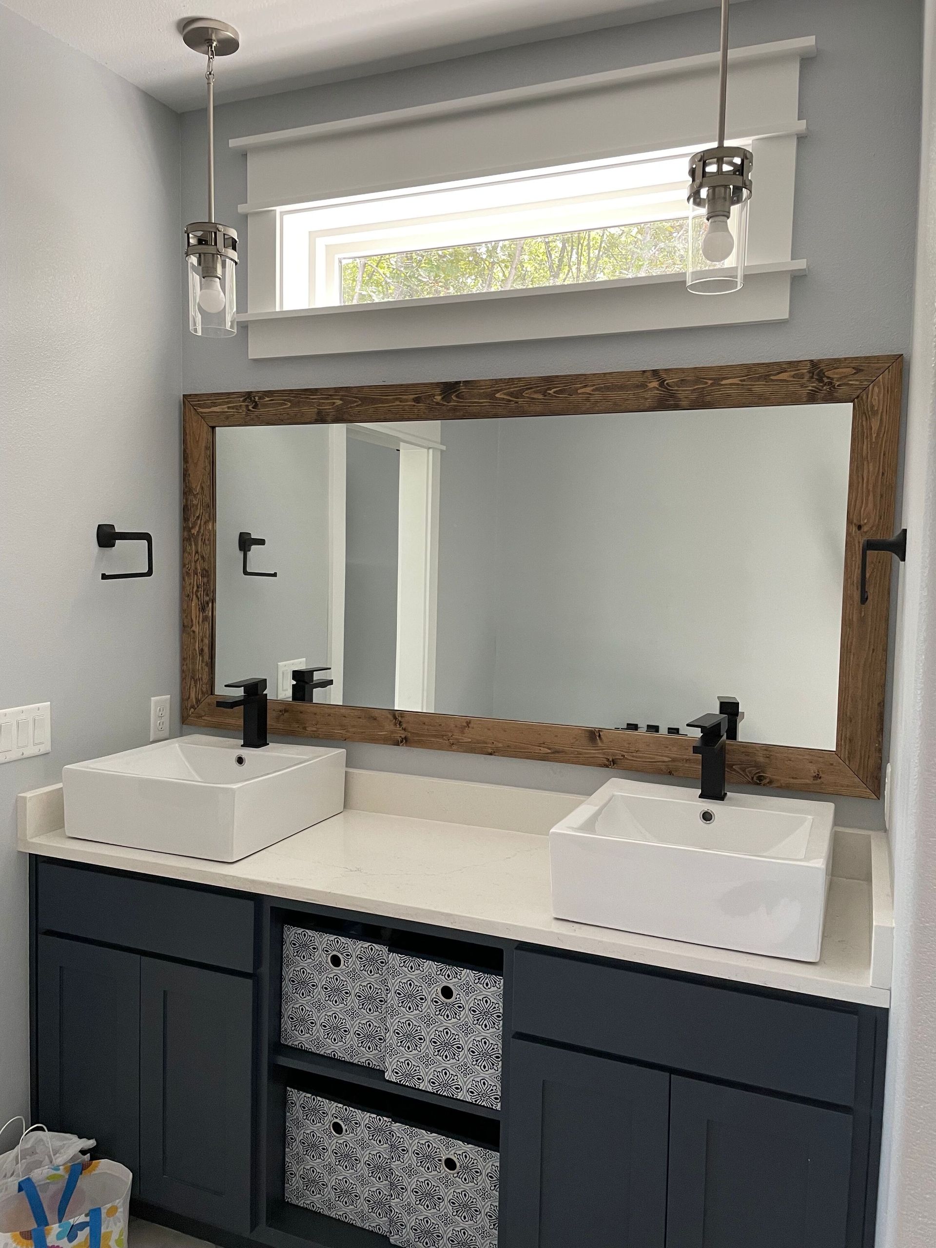 A bathroom with two sinks and a large mirror