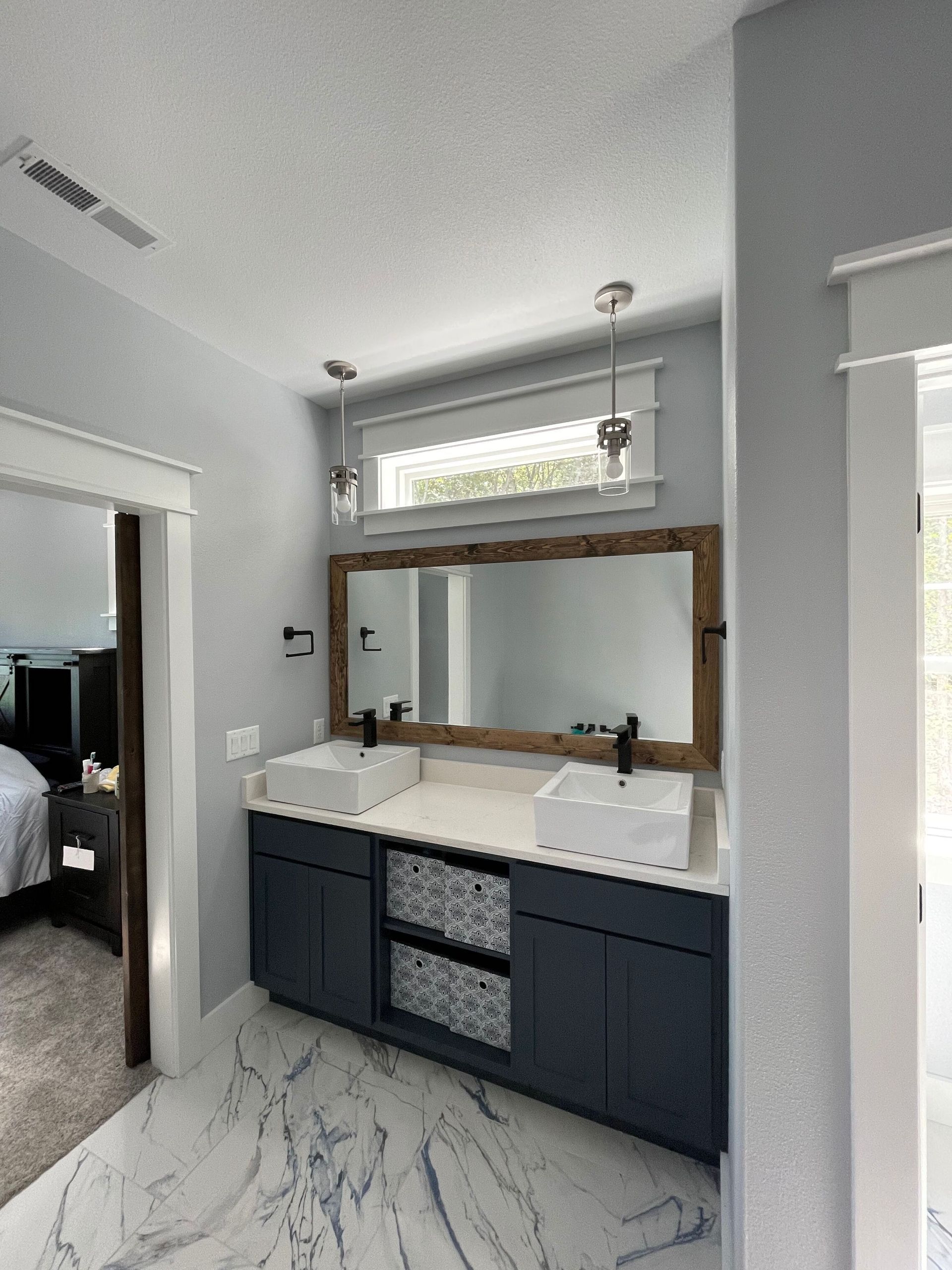 A bathroom with two sinks and a large mirror