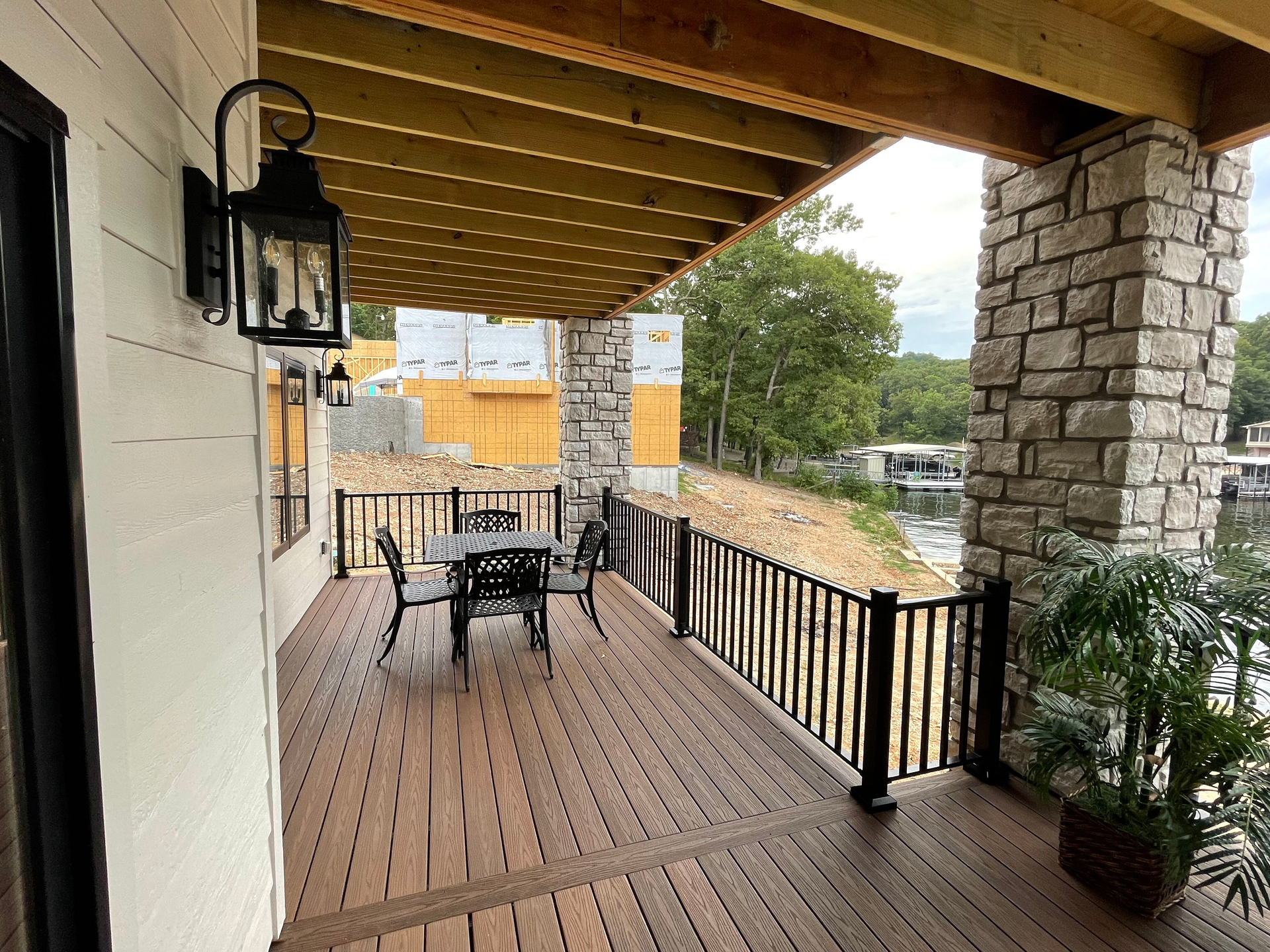 A wooden deck with a table and chairs on it.