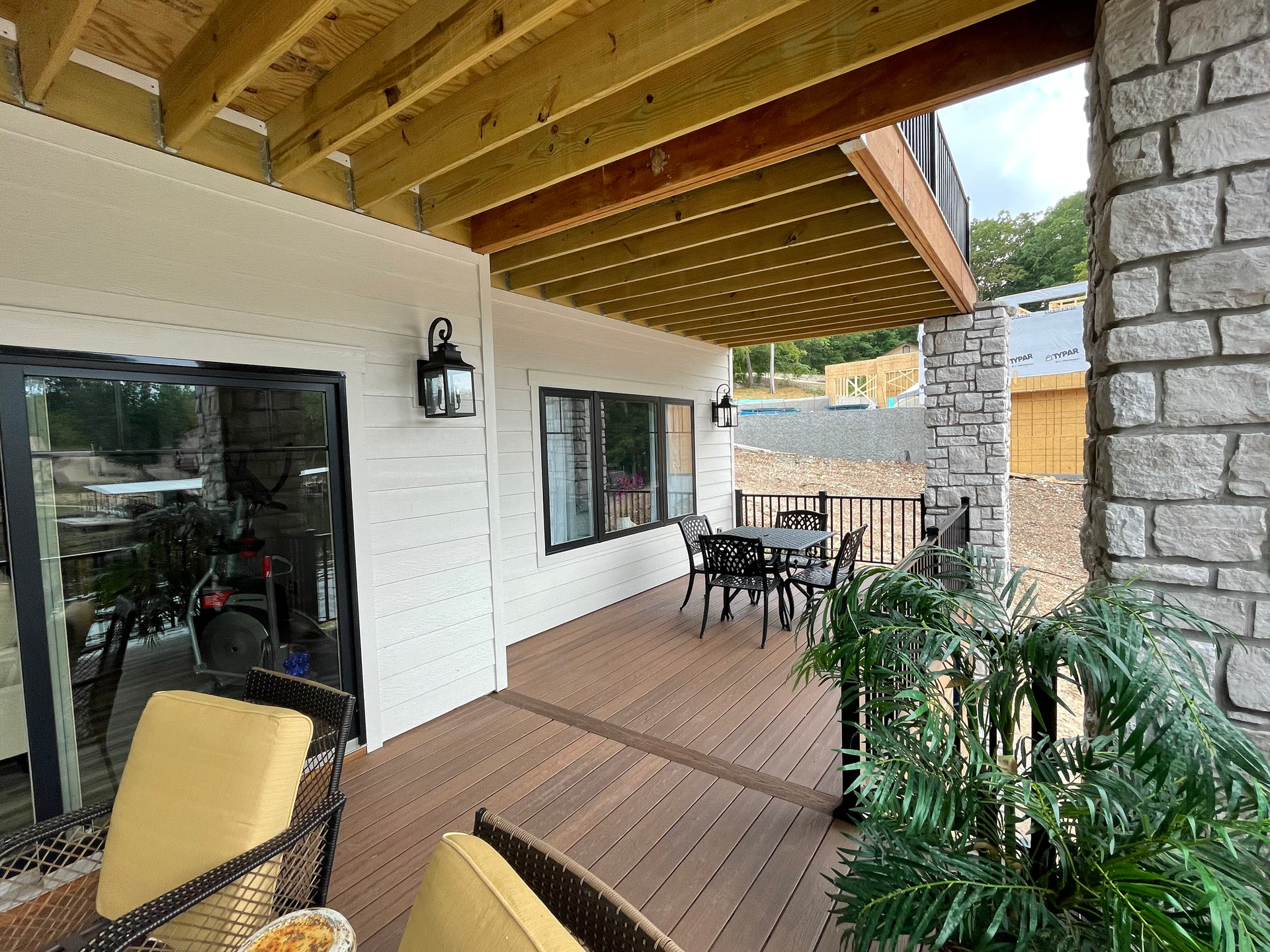 A wooden deck with a table and chairs on it.