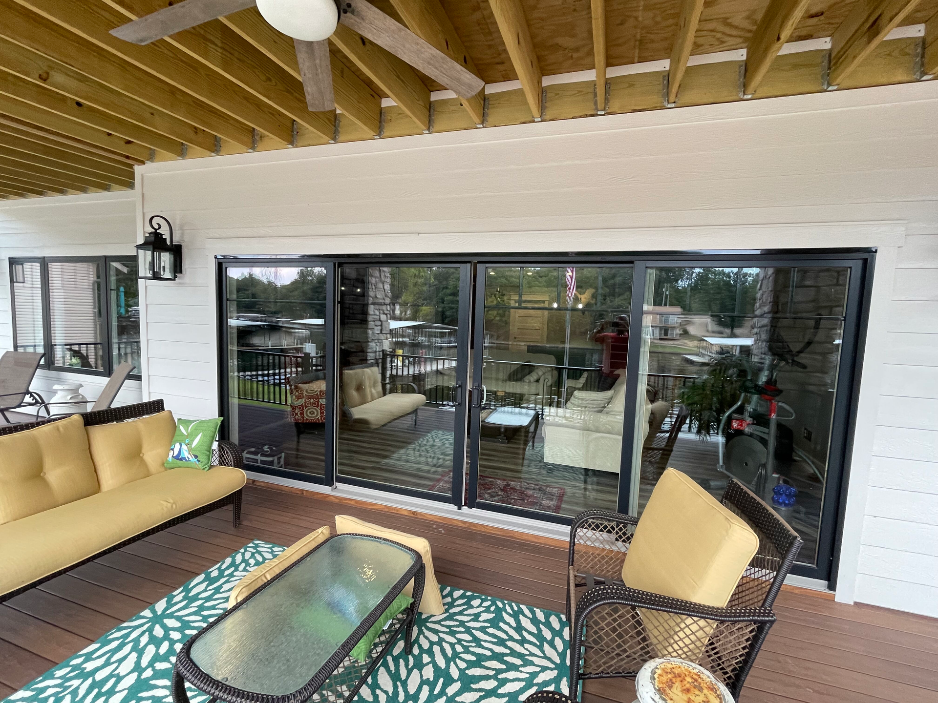 A patio with sliding glass doors and a ceiling fan.