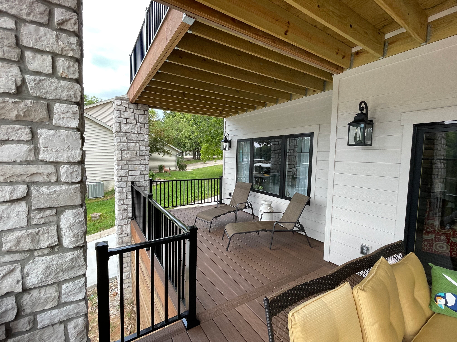 There is a deck with a couch and chairs on it.