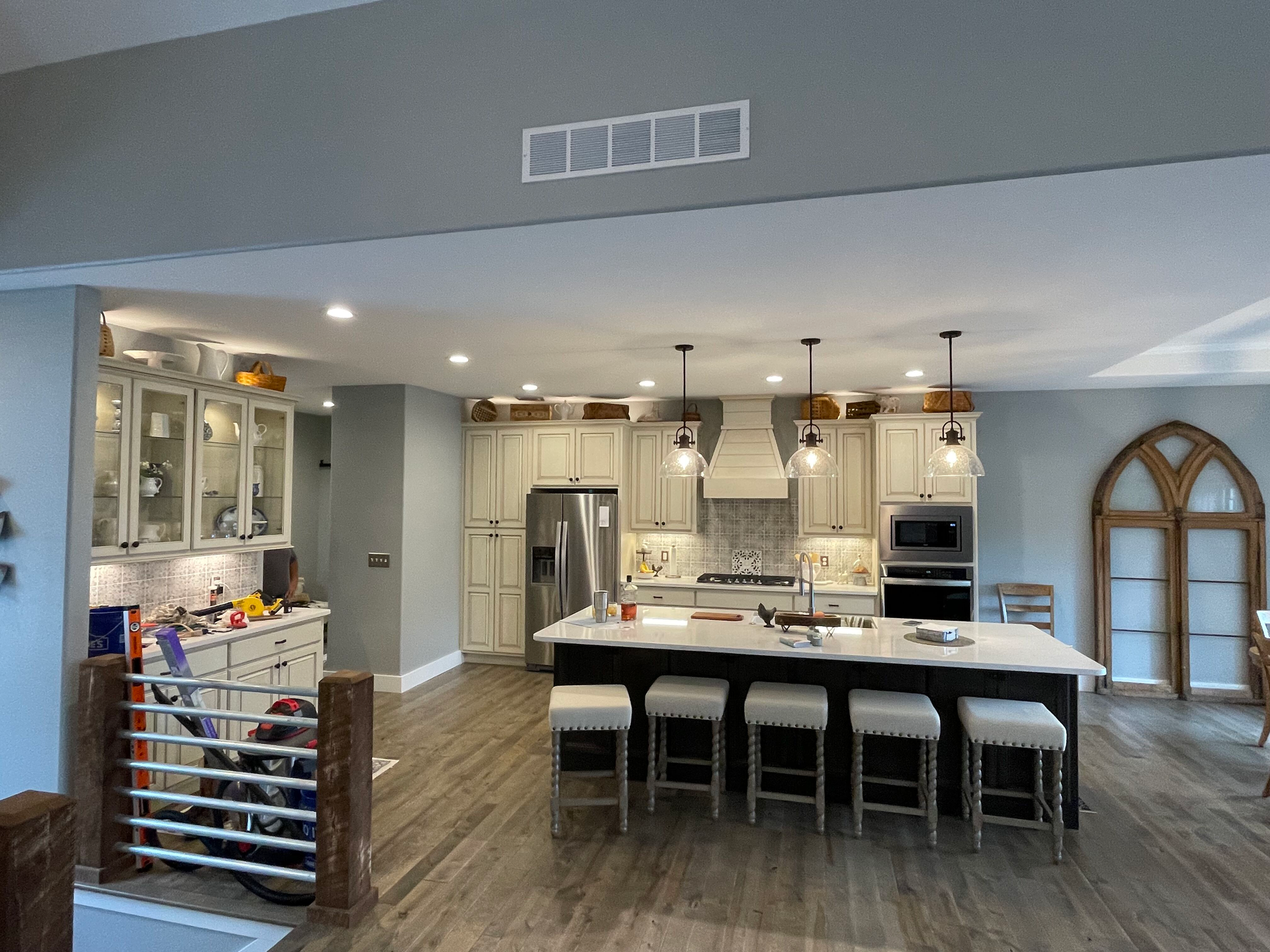 A kitchen with a large island and stools