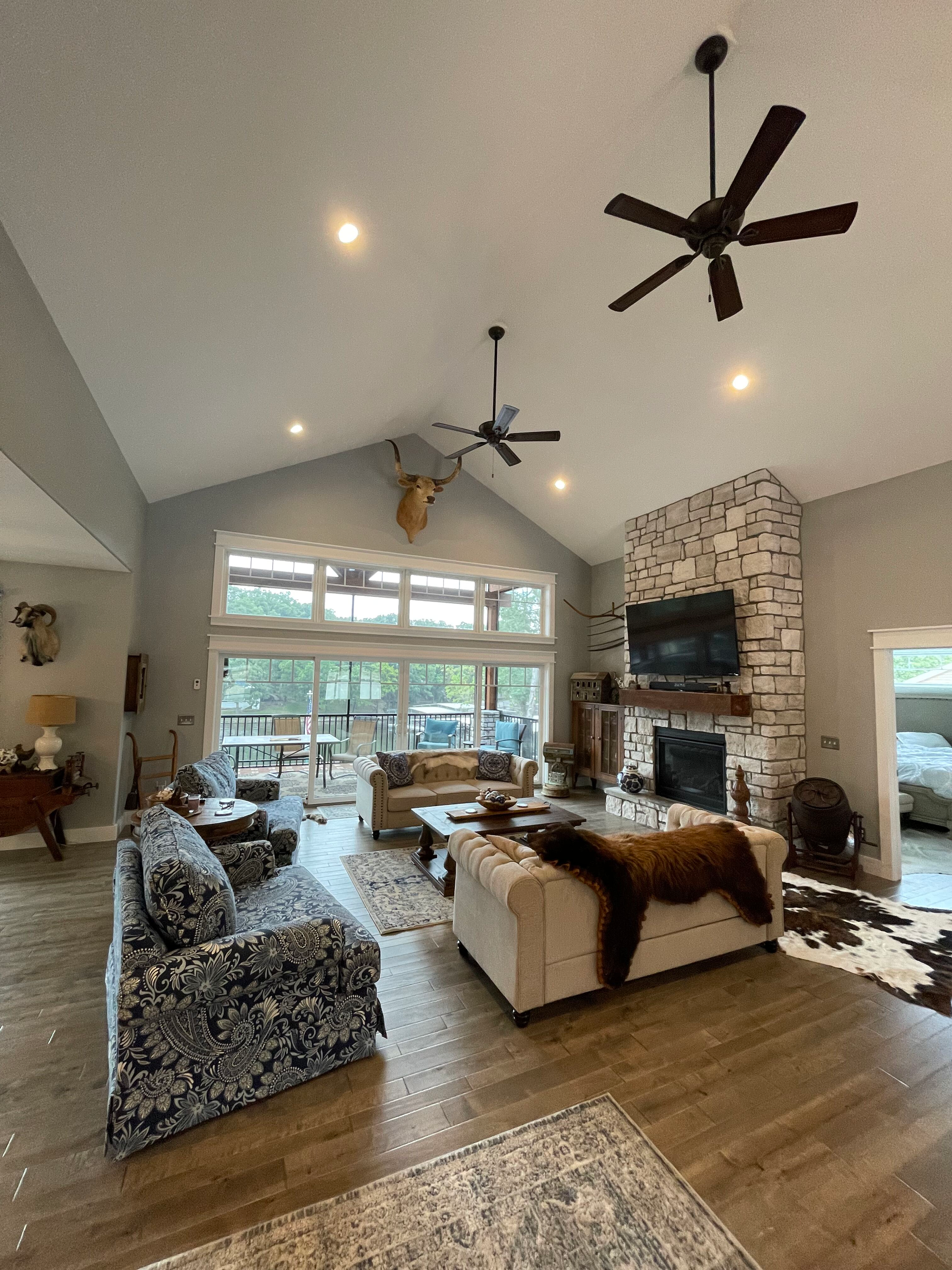 A living room with a vaulted ceiling and a fireplace.