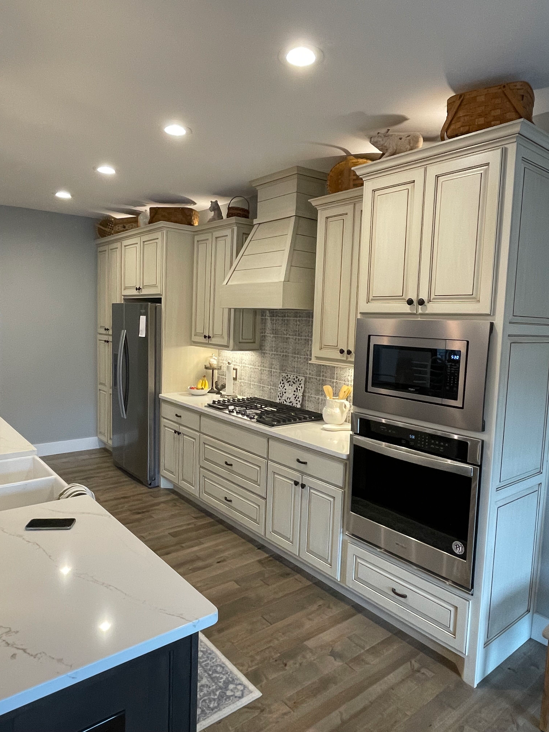 A kitchen with white cabinets and stainless steel appliances.
