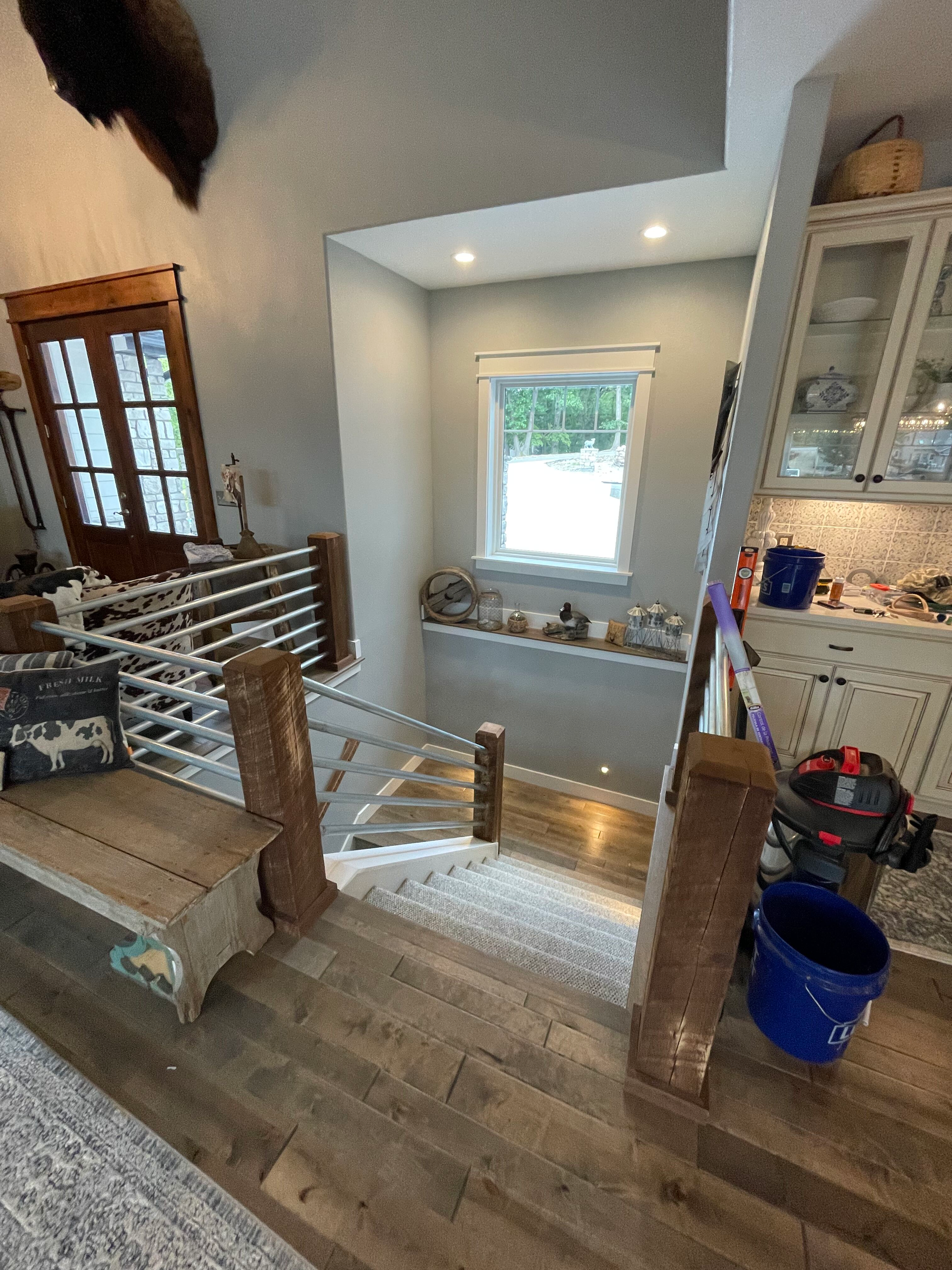 A picture of a staircase in a house with a vacuum cleaner.