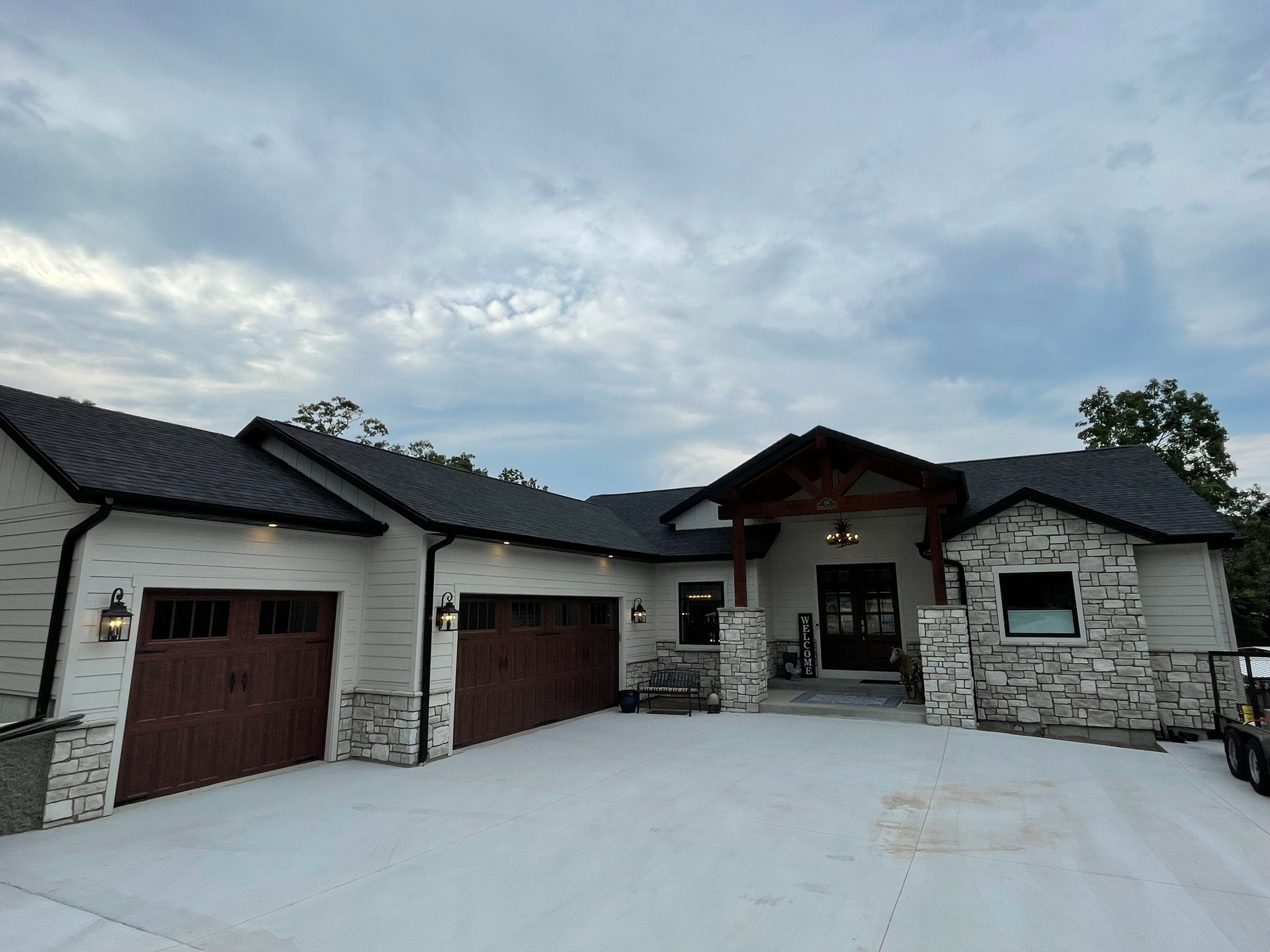 A large house with a lot of garage doors and a driveway.