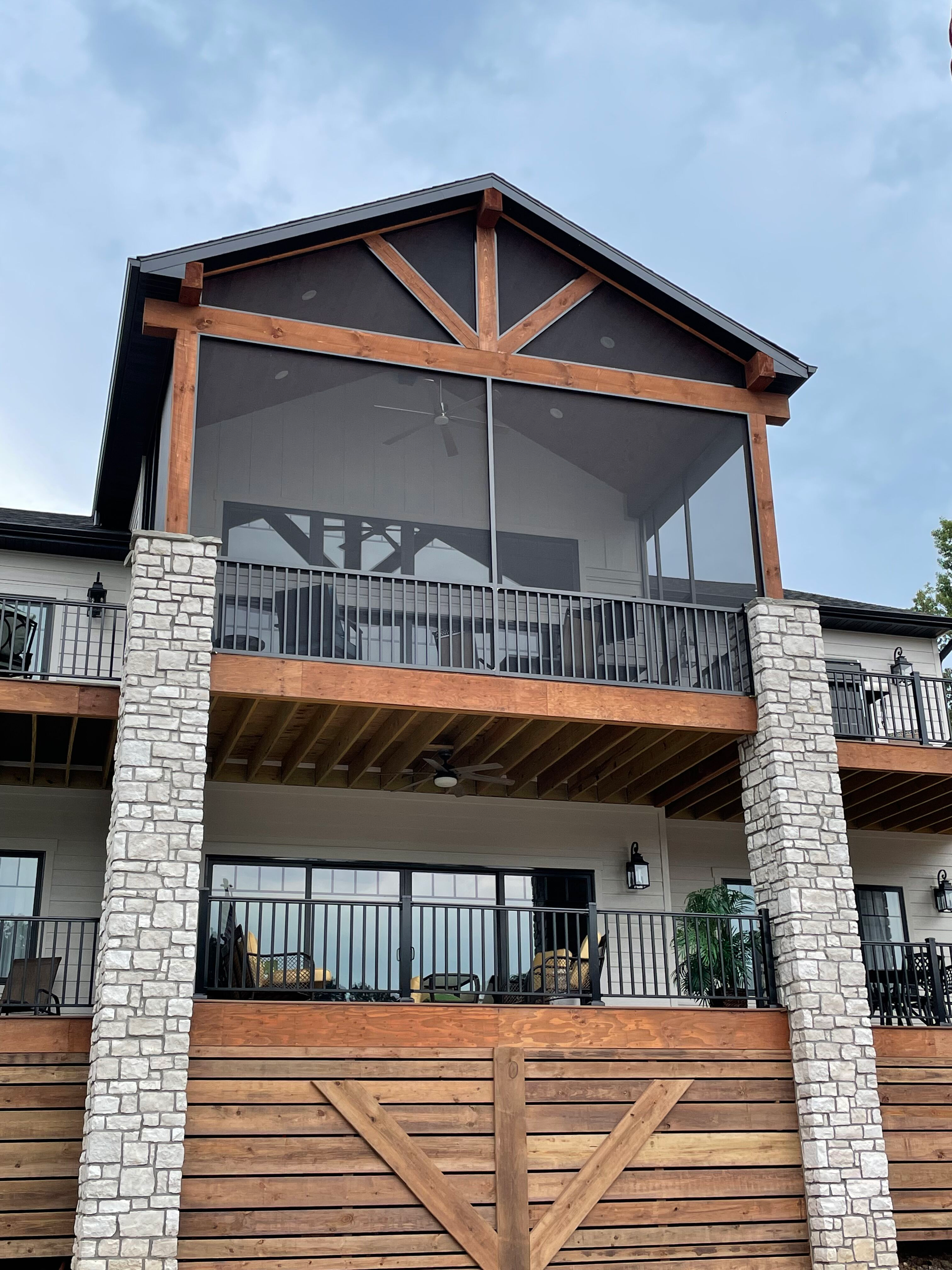 A large house with a screened in porch and balconies