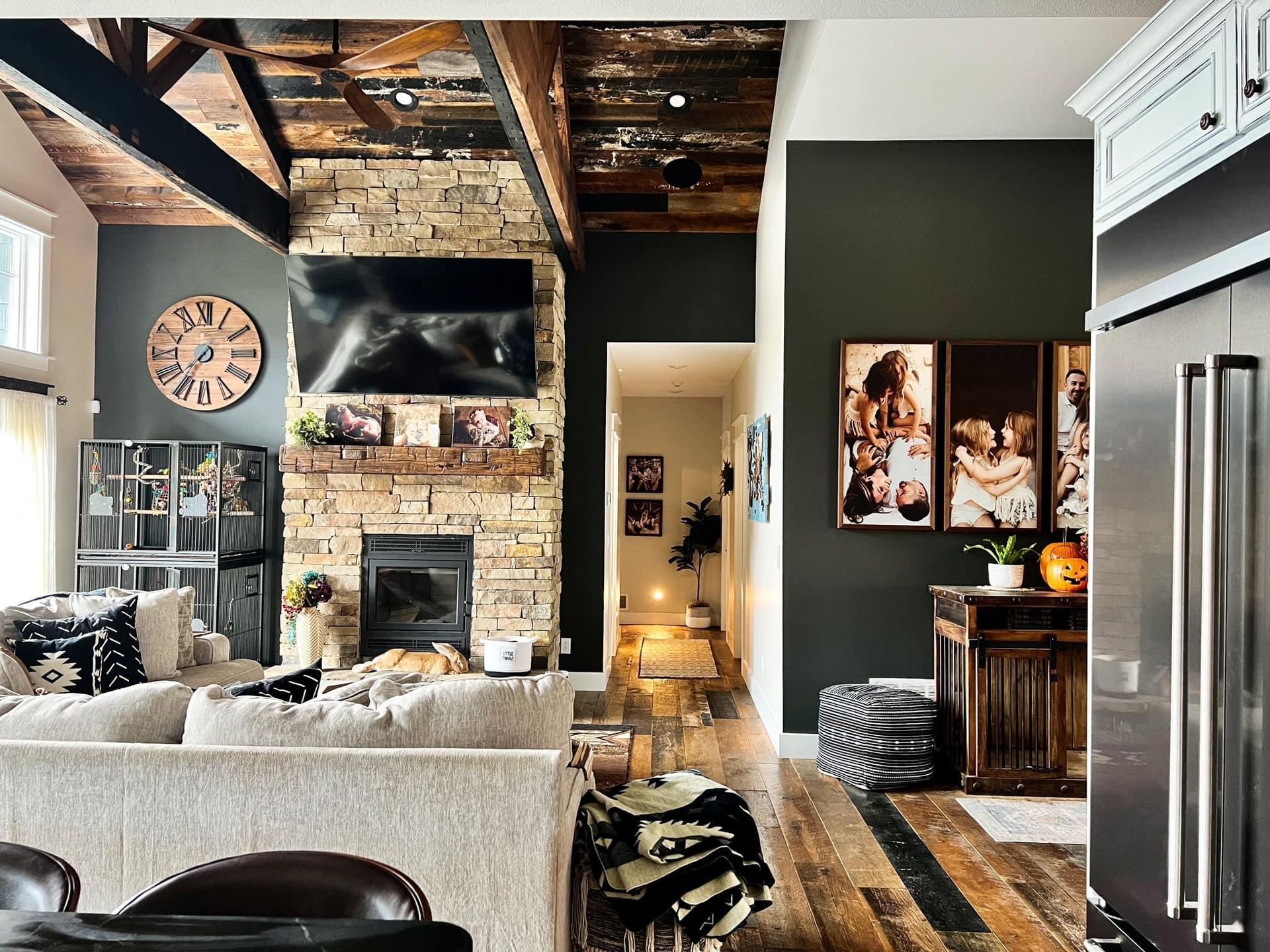 A living room with a couch , fireplace and television.