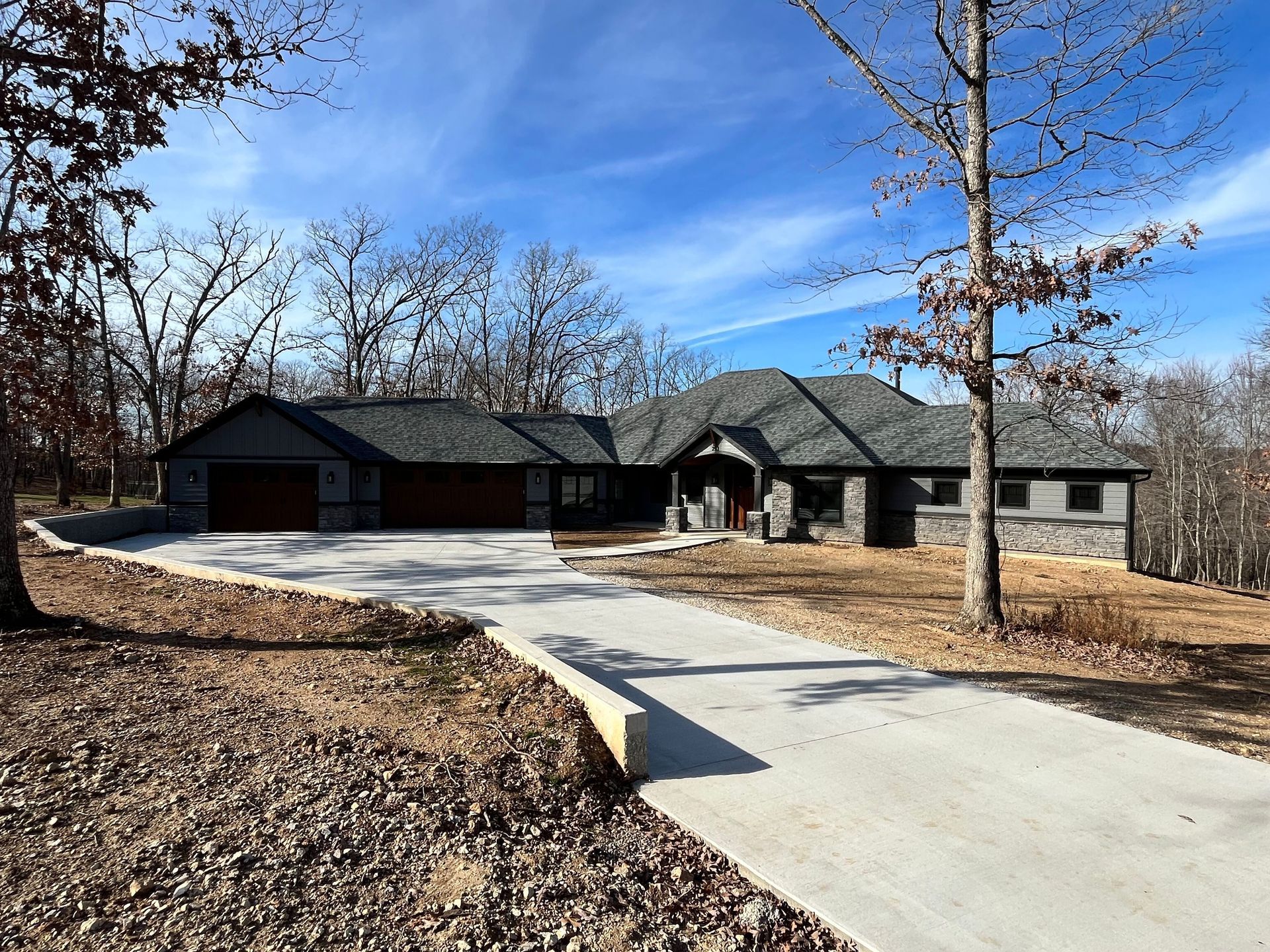 A large house with a concrete walkway leading to it