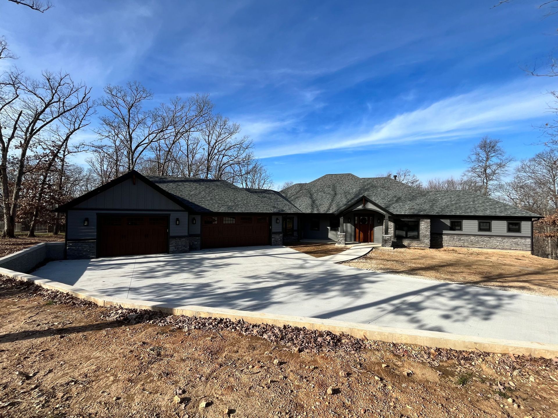 A large house with a concrete driveway in front of it.