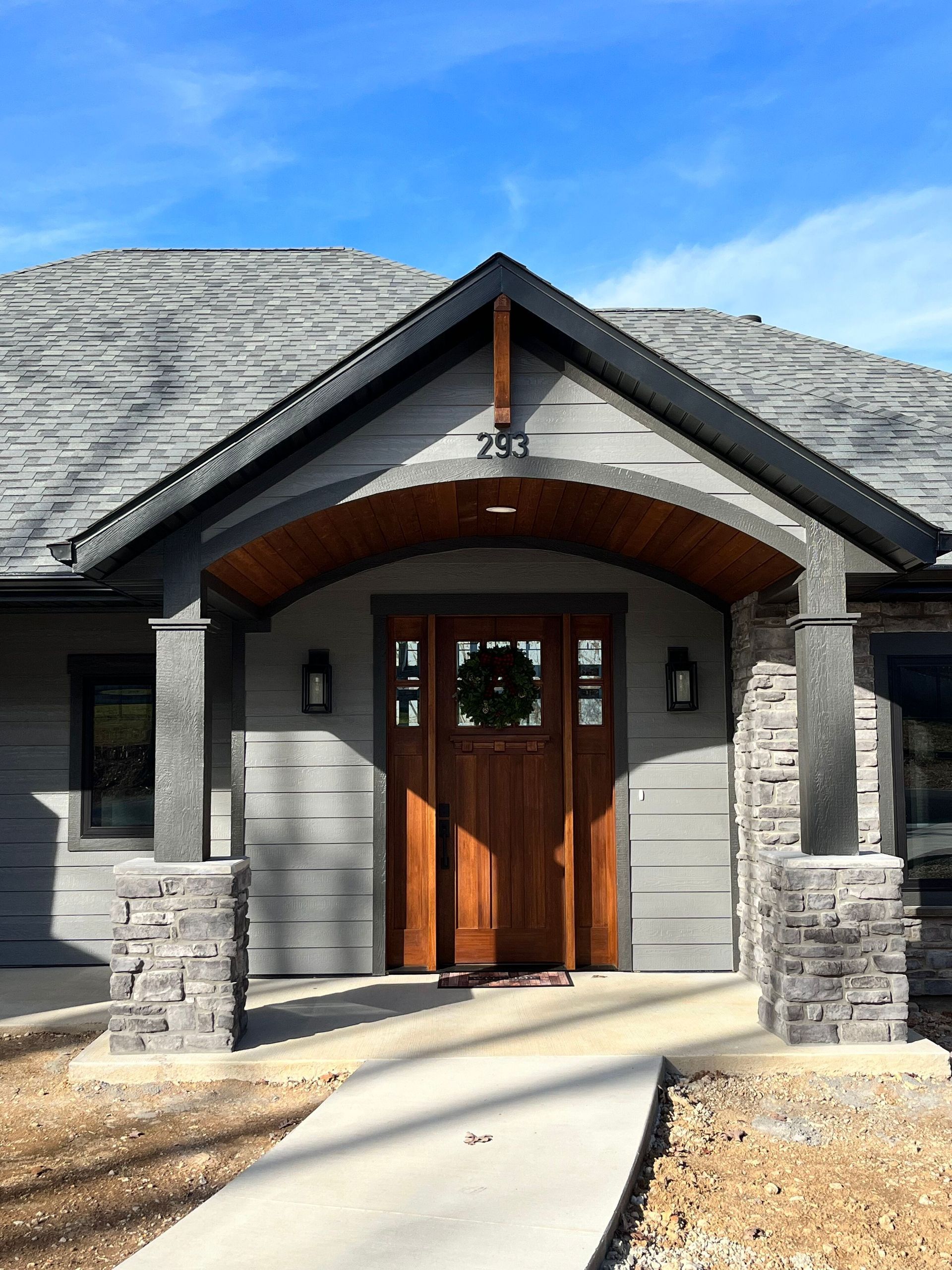 The front door of a house with a wreath on it