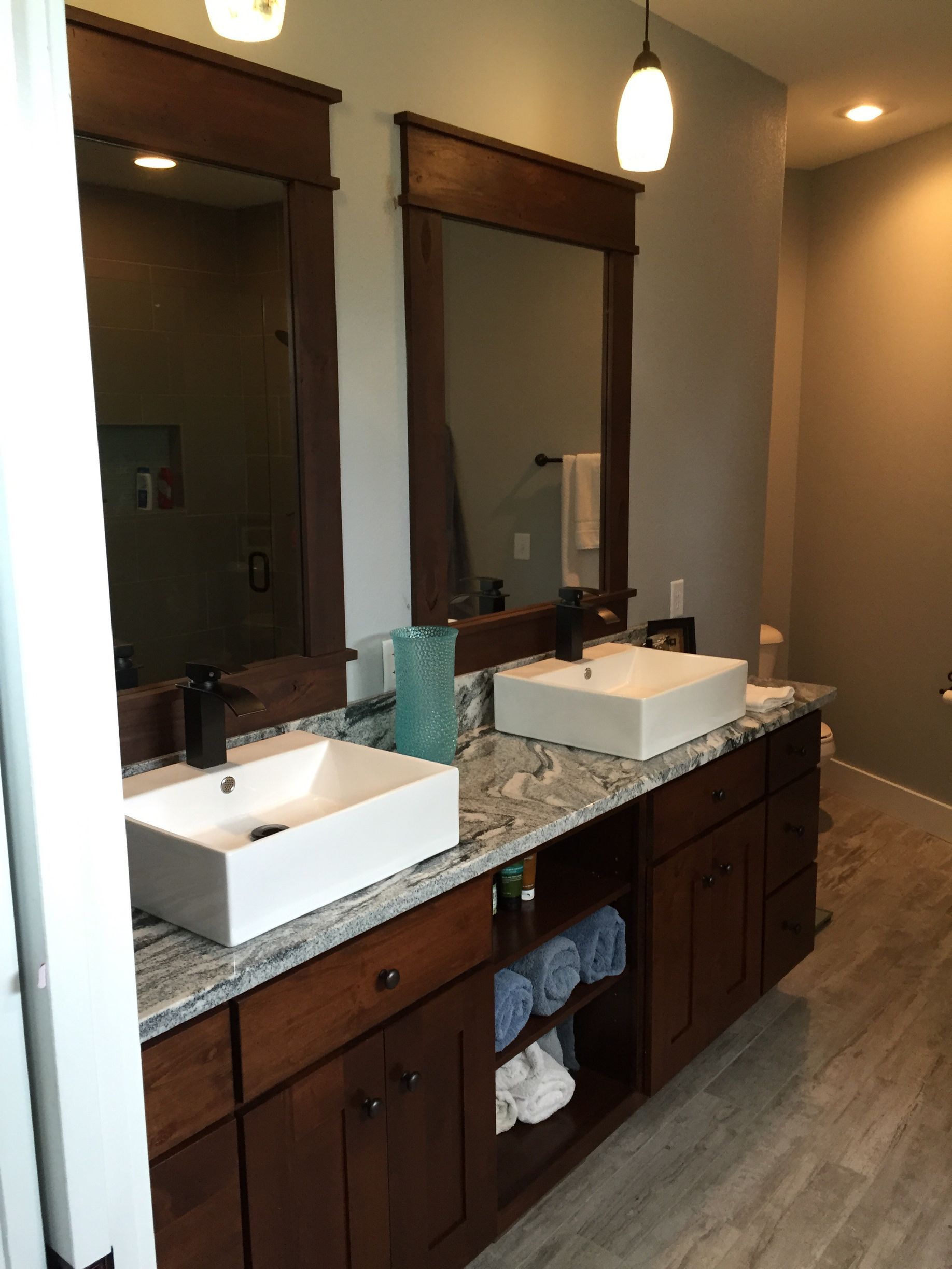 A bathroom with two sinks and two mirrors.