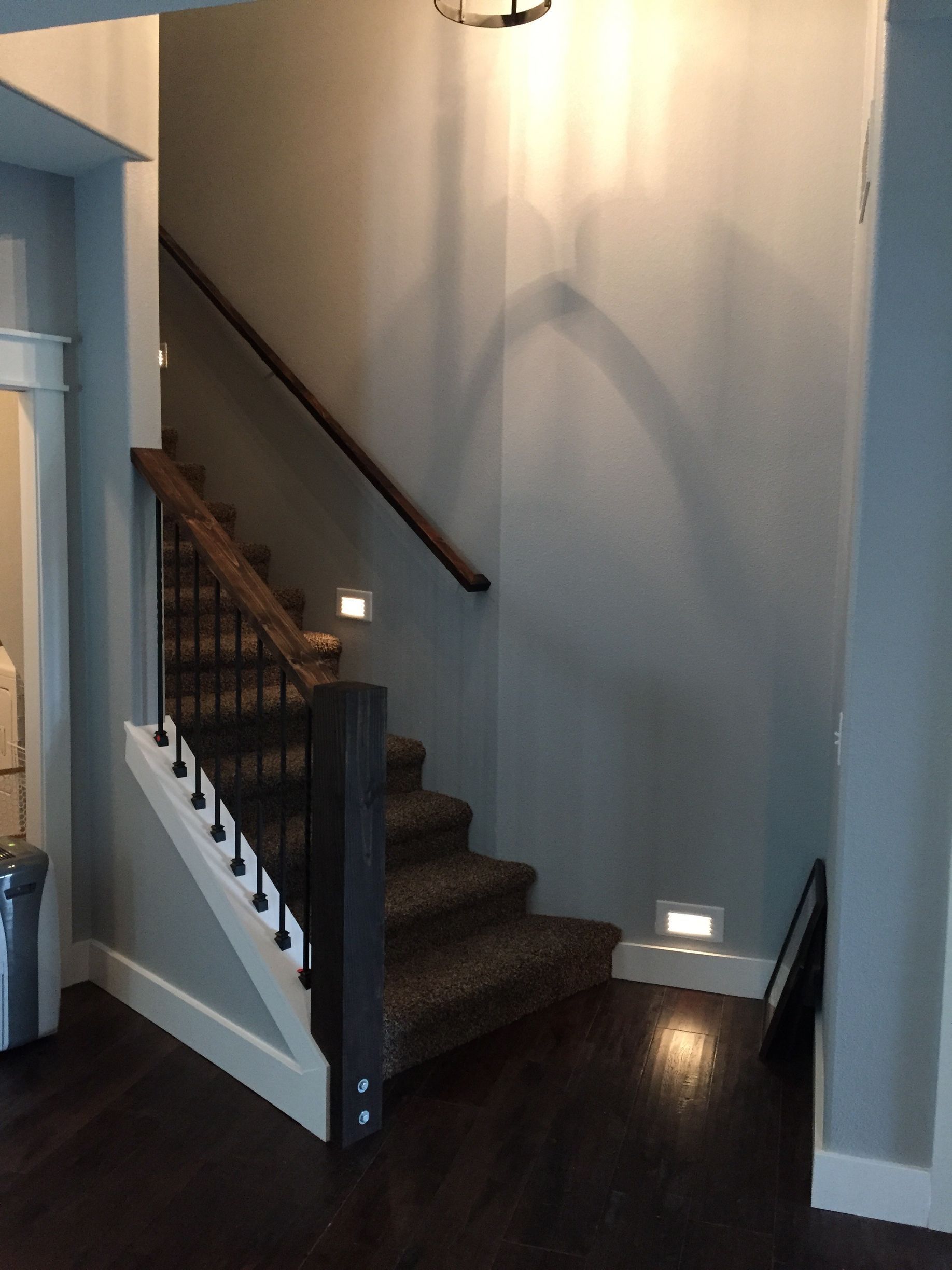 A staircase in a house with a wooden railing