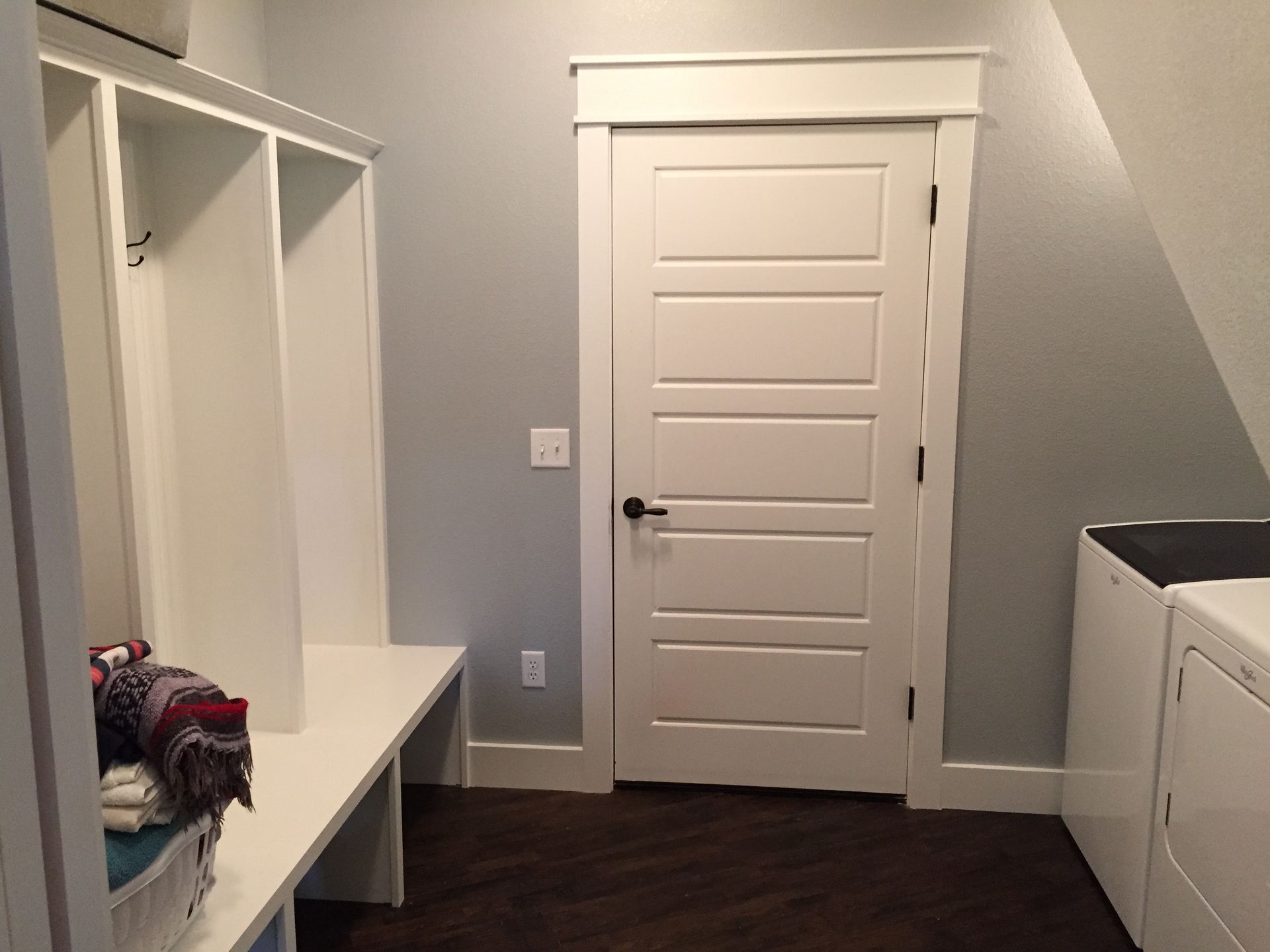 A laundry room with a washer and dryer and a door