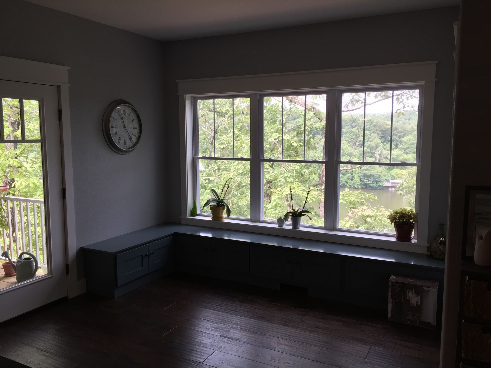 There is a clock on the wall above the window.