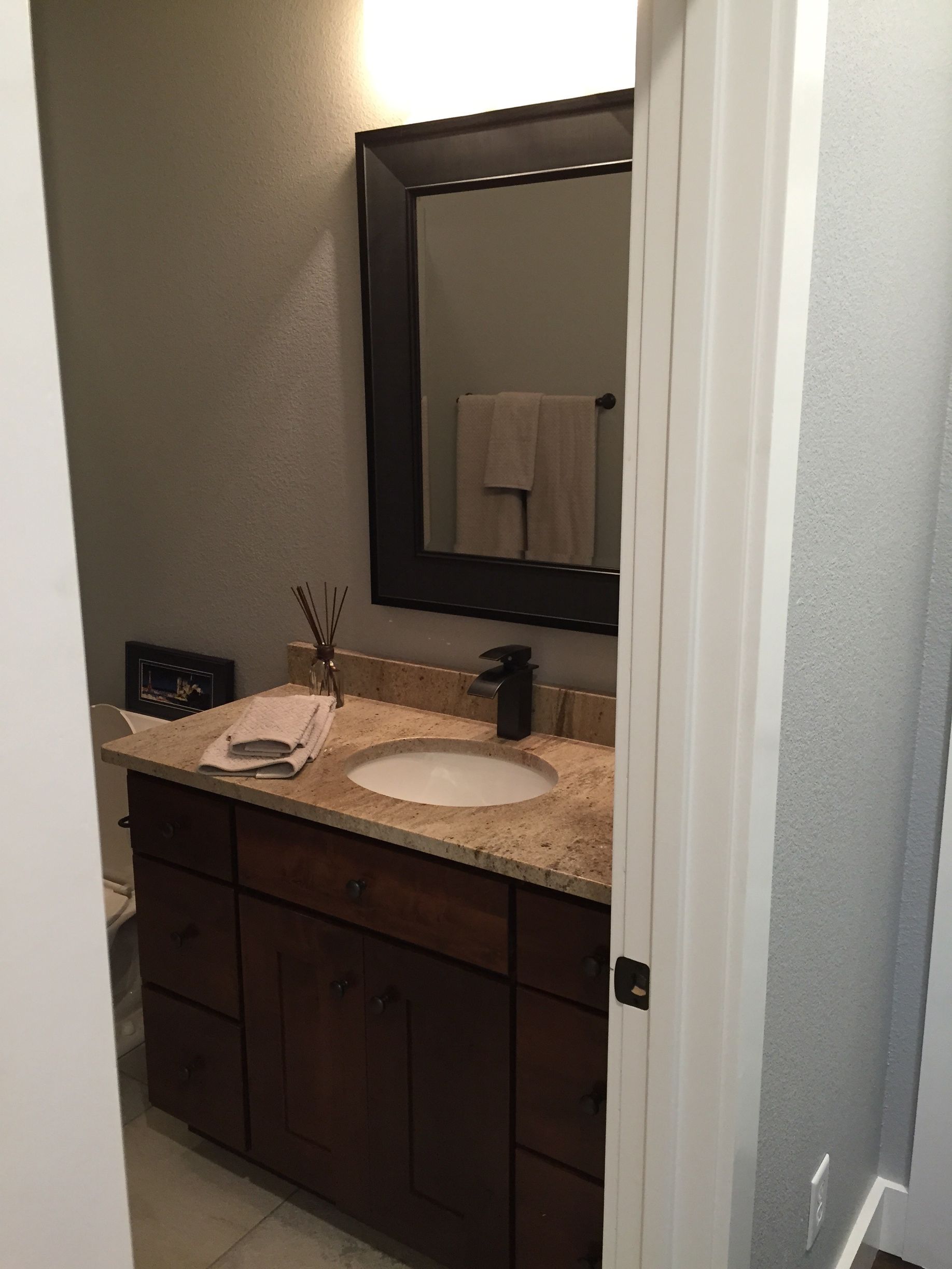 A bathroom with a sink and a mirror on the wall