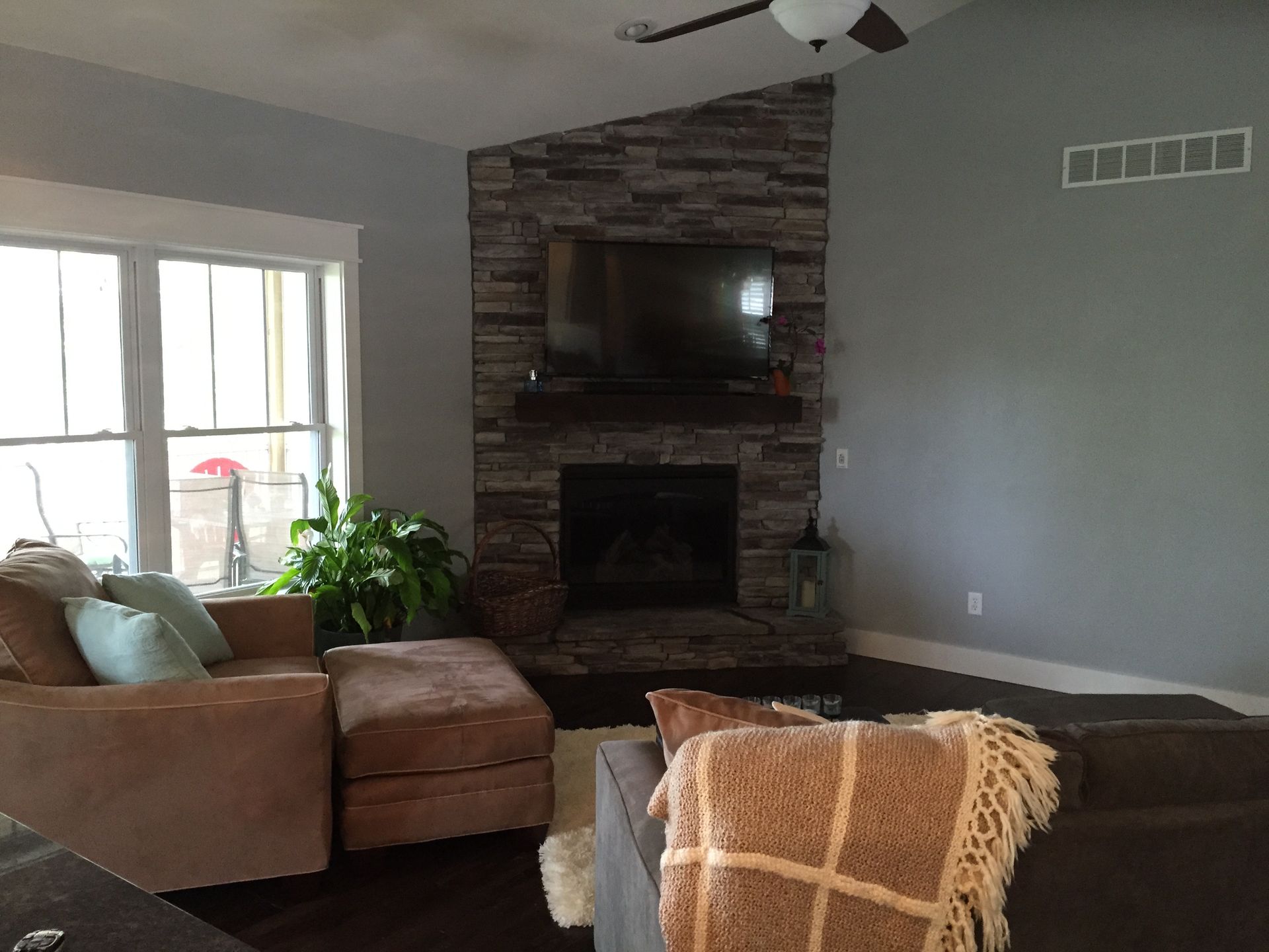 A living room with a fireplace and a flat screen tv