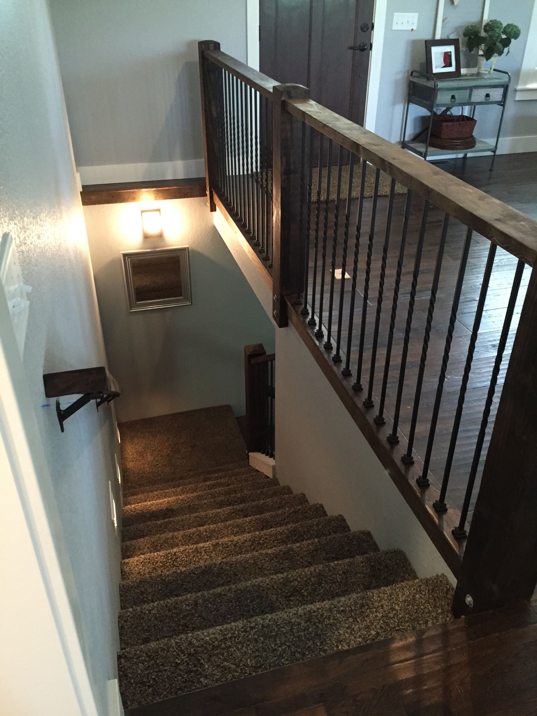 A staircase in a house with a railing and carpeted steps