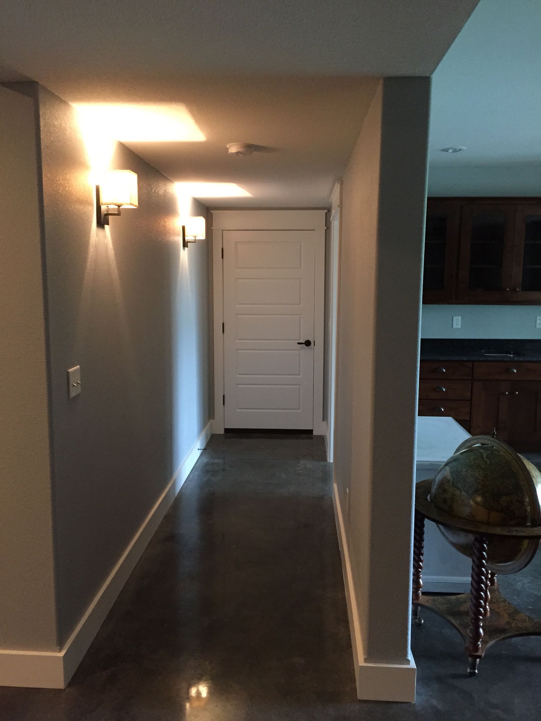 A long hallway in a house with a white door