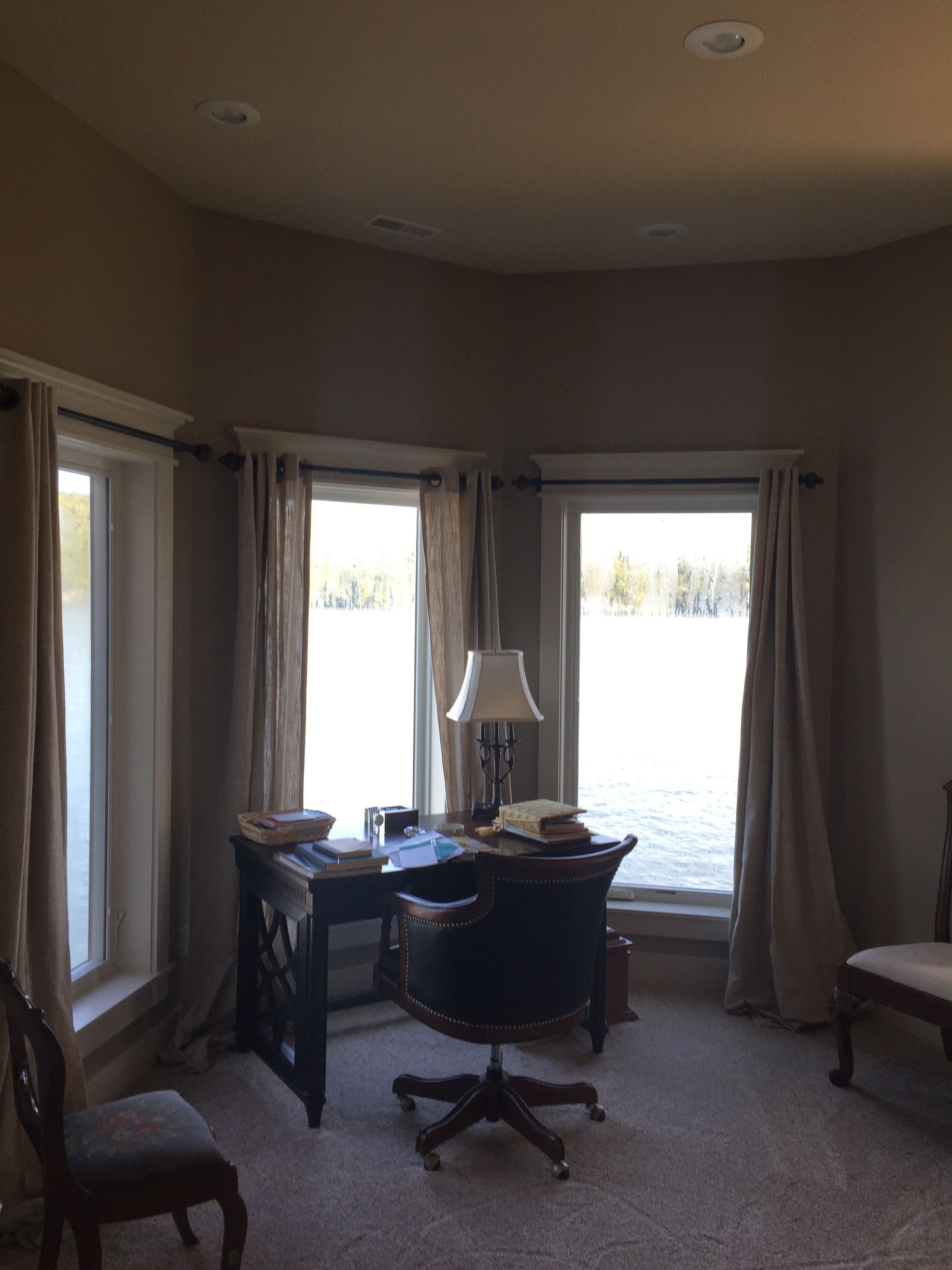 A room with a desk and chair and a lamp